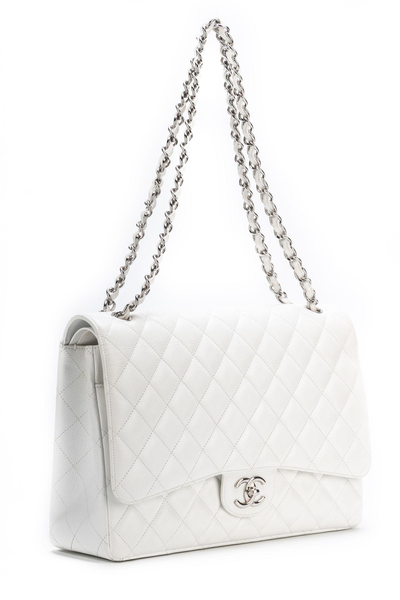 Chanel excellent condition maxi flap in white caviar leather and silver tone hardware. Collection 15. Shoulder drop 11”/19” Comes with hologram and original box.