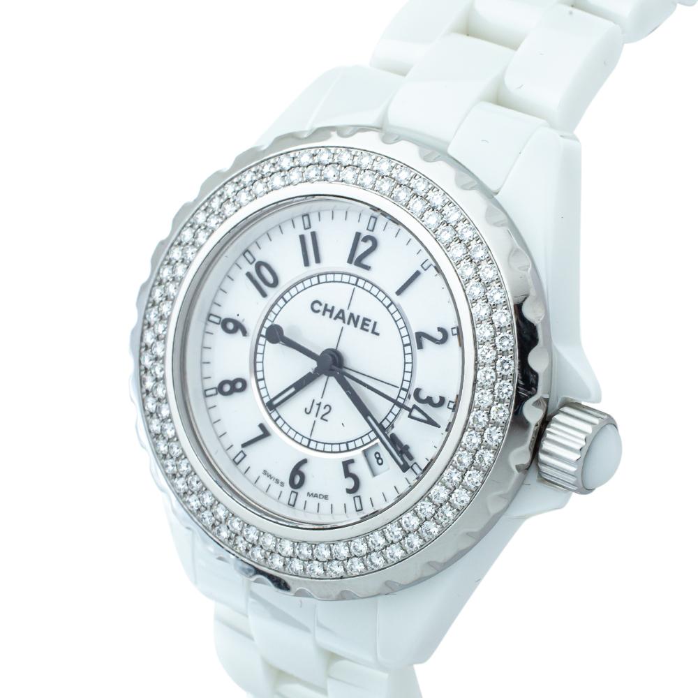The Chanel J12 watch exudes sophistication and brilliant craftsmanship. It has a white ceramic and stainless steel case and a bezel that is adorned with shimmering diamonds. Functioning on quartz movement, it features a white dial that is detailed