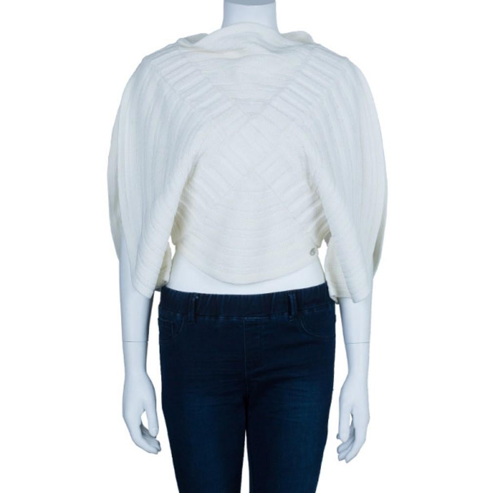 This Chanel Circular Knit Top is a runway piece! It features a unique circular shape, with a swirl stitched pattern and a criss-cross shape running through its middle. This top also has silver-tone Chanel hardware at its bottom.

Includes: The