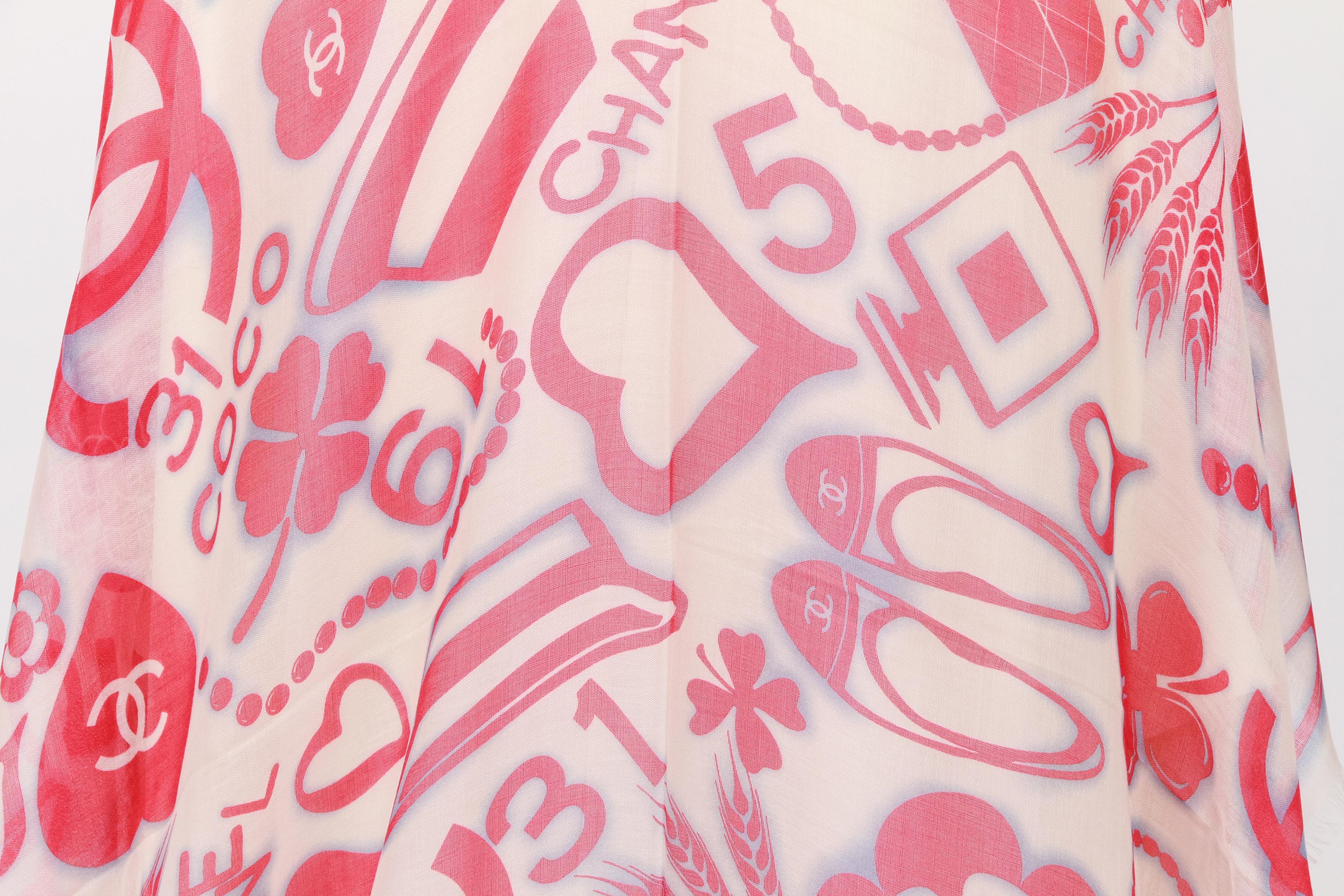 Chanel brand new 65% cashmere 35% silk white, coral and celeste shawl. Iconic symbols design. New in unworn condition. Please refer to photo for small pulled thread .