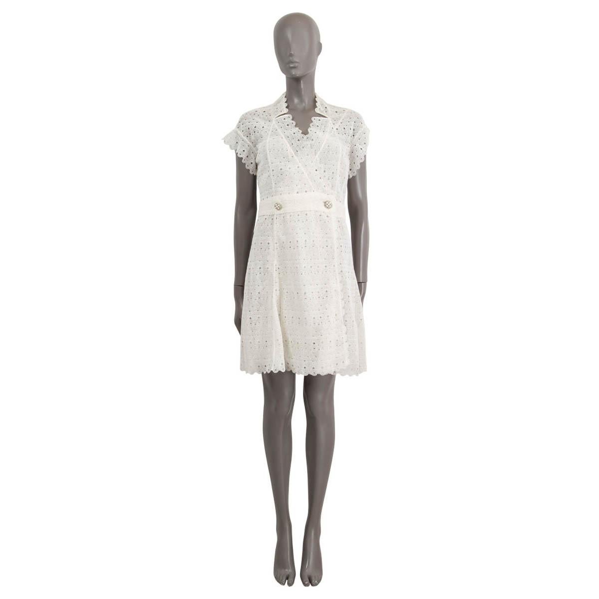 100% authentic Chanel crochet wrap dress in white cotton (100%). Opens with two Gripoix stone embellished buttons on the front. Features short sleeves and V-neck. Comes with slip dress in silk (100%) with lace trim along the hemline. Has been worn