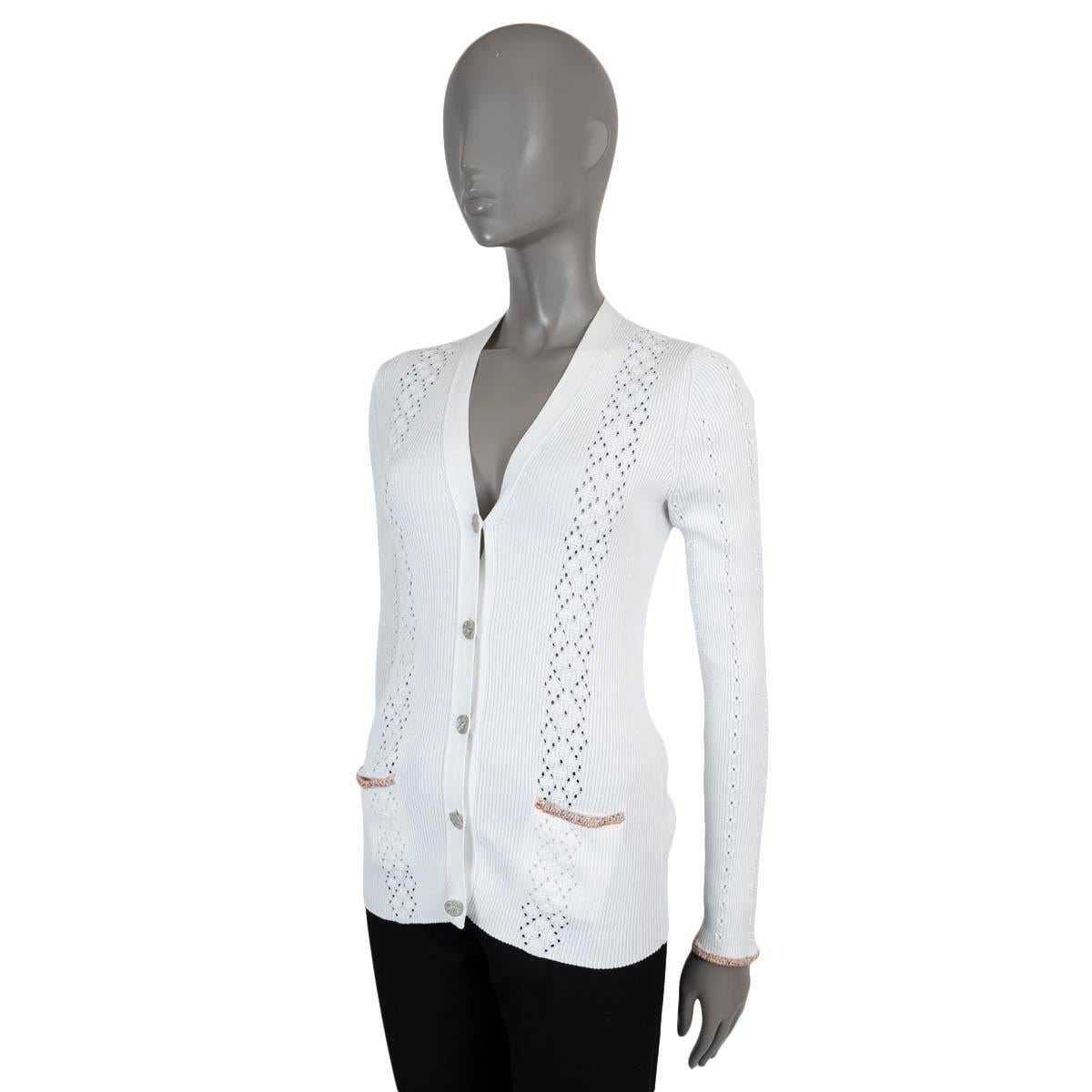 100% authentic Chanel cardigan in white rib-knit cotton (100% - please note the content tag is missing). Features a V-neck, pointelle stripes and tweed trims in orange and pink. Closes with Coco Cuba buttons. Has been worn and shows very faint