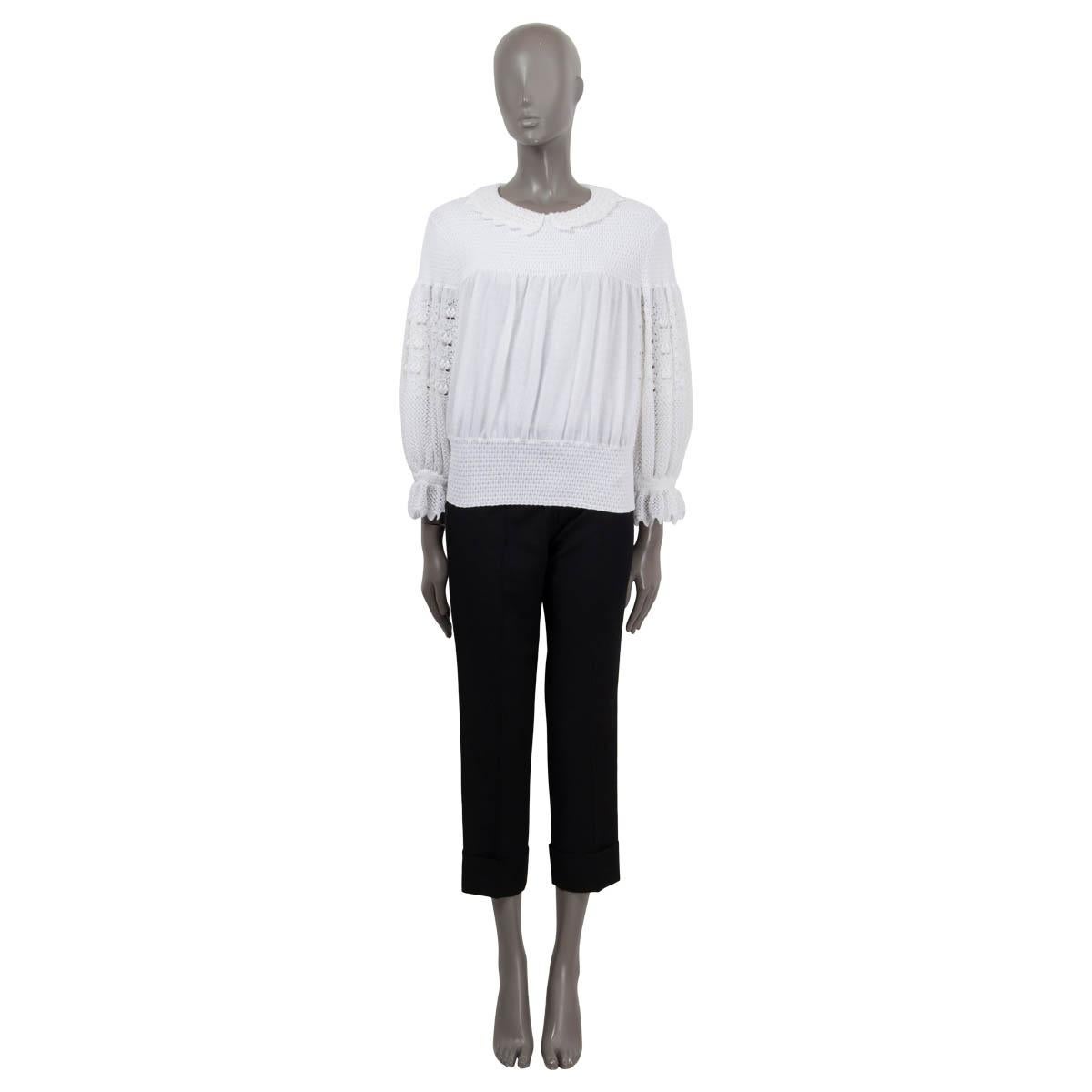 100% authentic Chanel Peter Pan collar sweater in white cotton (77%), polyamide (22%) and elastane (1%) with elastic band and scalloped edges on cuffs and collar. The design features three light gold-tone logo and pearl embellished buttons on the