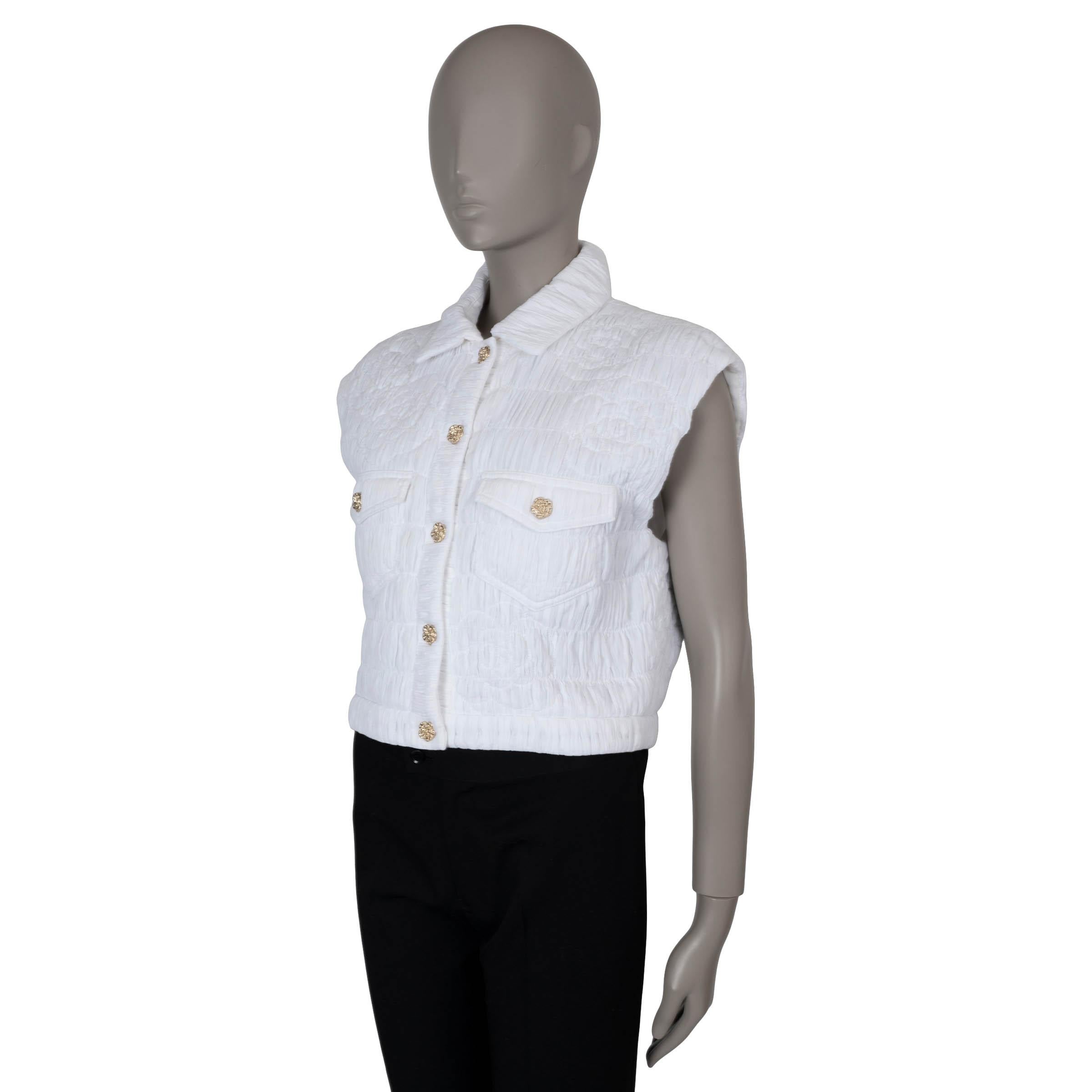 This 100% authentic Chanel ruched bomber vest in white cotton combines sporty style with classic Chanel elegance. It features a short silhouette with iconic Camellia quilting and two buttoned flap pockets for a chic, structured look. The vest closes