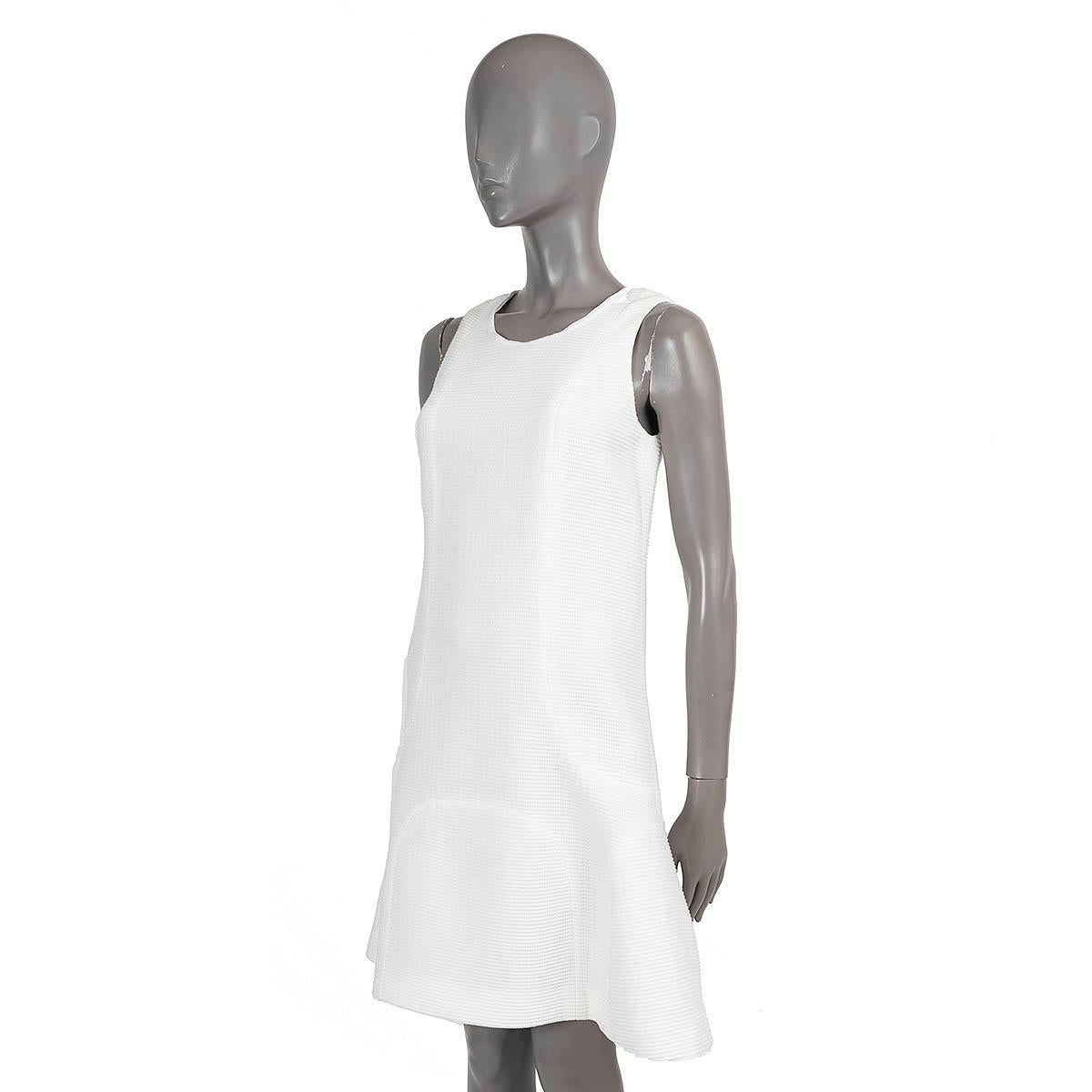 100% authentic Chanel ribbed short trumpet dress in off-white cotton (81%) and nylon (19%). Closes with hook and invisible zipper on the back. Lined in black silk (100%). Has been worn and is in excellent condition. 

2012