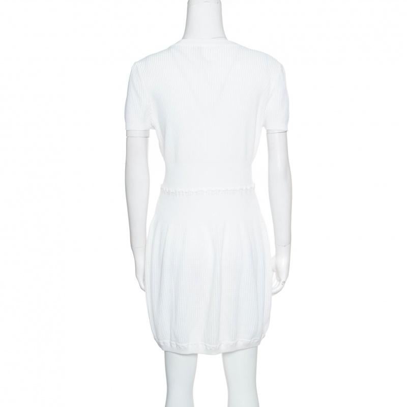 From Chanel's Spring 2009 collection twirls in this white dress that has been finely tailored from quality cotton and designed with rib trims, short sleeves and the CC logo on the front. It will make a great choice for days under the sun.

Includes: