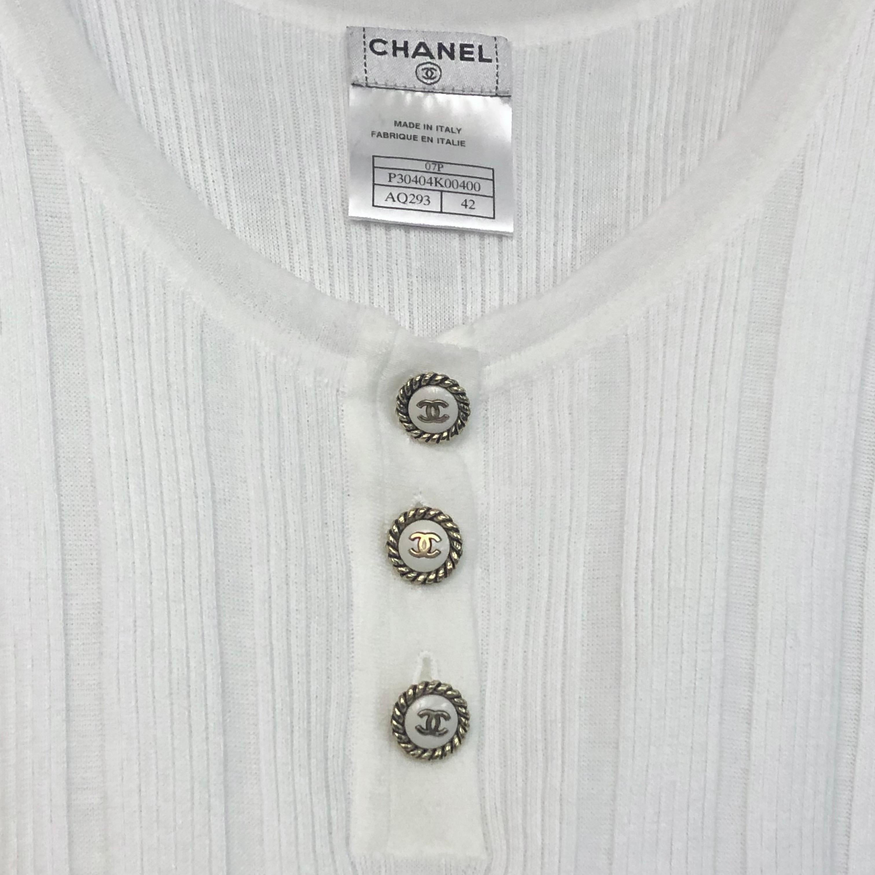 - Chanel white cotton tank top from spring 2007 collection. Timeless piece meant to last for  decades!. 

- Featuring three white and gold hardware buttons. 

- Size 42. 

