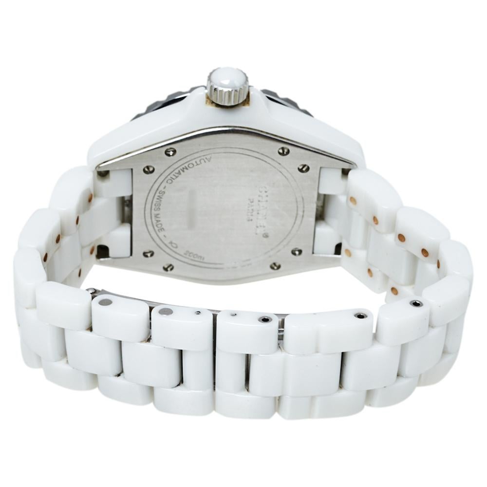 Flaunt this gorgeous timepiece by Chanel on your wrist and capture everyone's admiring glances. This wristwatch is made from white ceramic. It has a uni-directional rotating, stainless steel bezel embellished with diamonds and on the white dial,