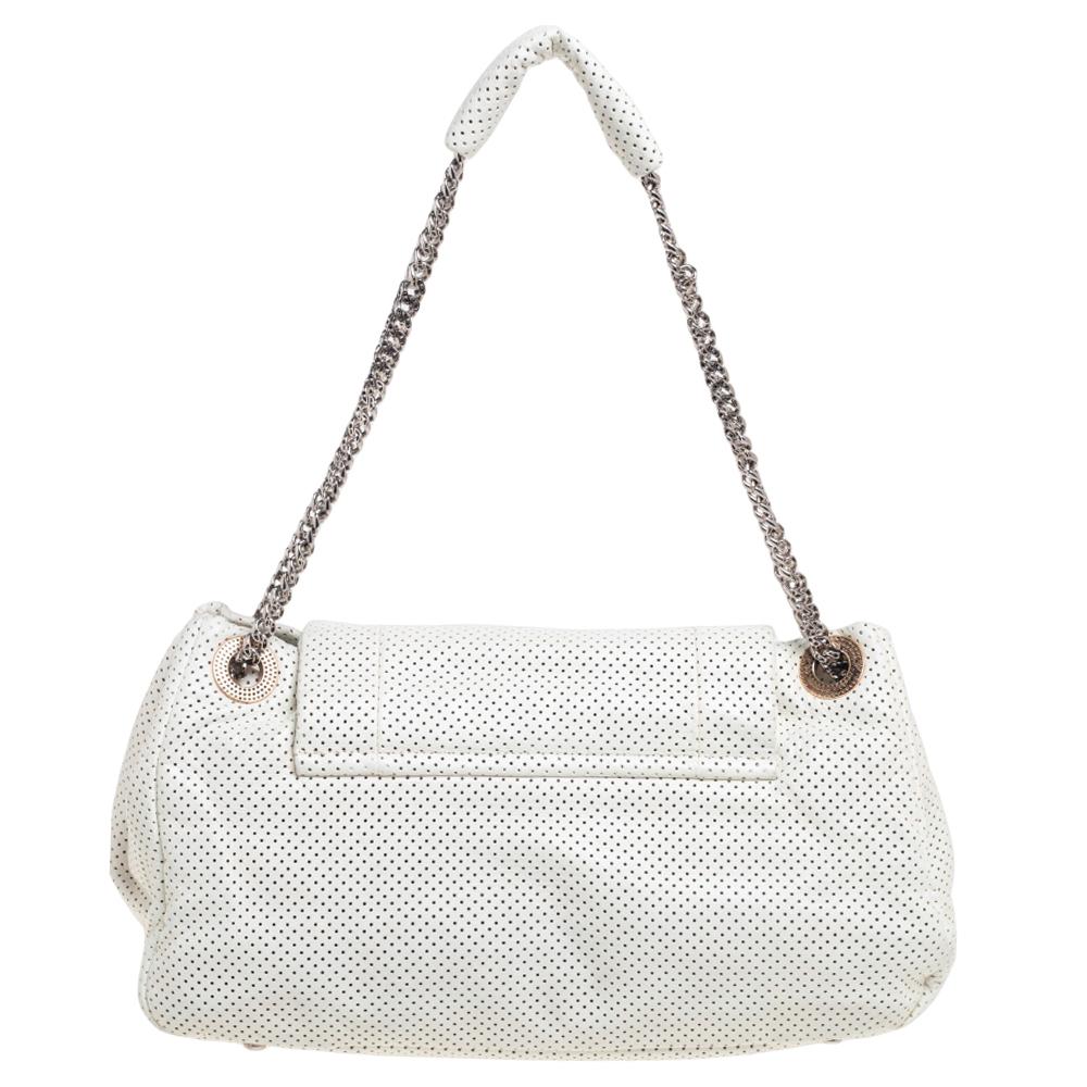This Chanel bag has it all! From the white perforated leather exterior to the roomy interior and the twist-lock at the front, this bag will definitely redefine what you think of a day bag. The satin-lined interior is spacious and has pockets. This