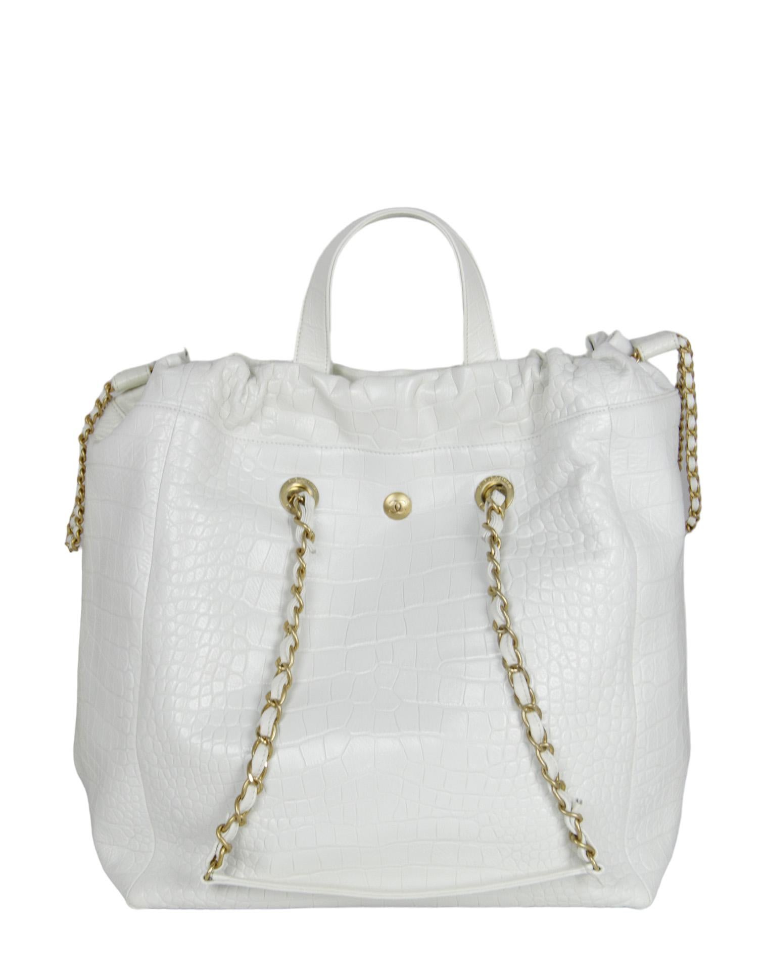 Chanel White Embossed Croc Paris-New York Large Coco Tote Bag. Features adjustable cinch at top

Made In: Italy
Year of Production: 2019
Color: White
Hardware: Goldtone
Materials: Embossed crocodile print leather
Lining: Black fine