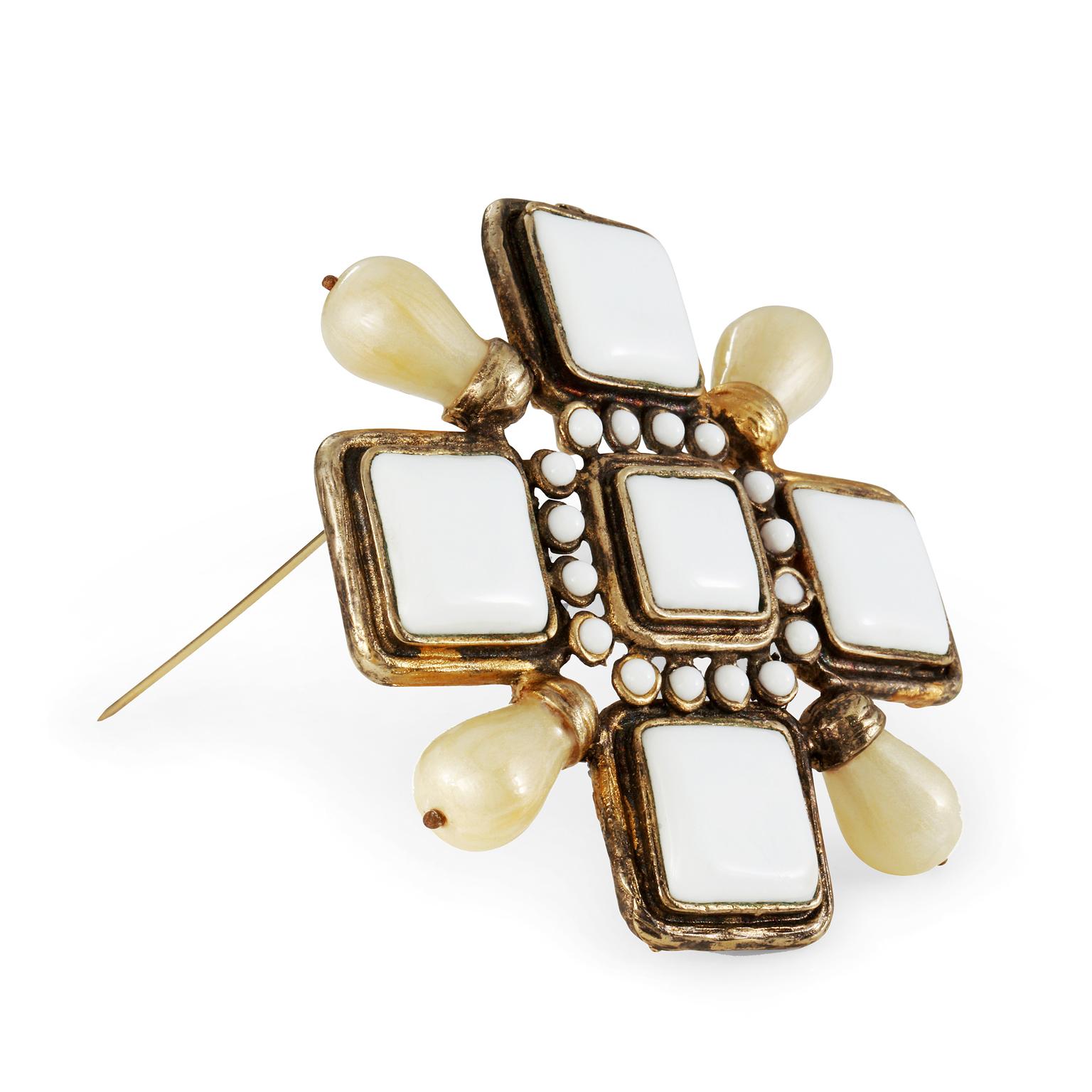 This authentic Chanel White Enamel and Pearl Maltese Cross Pin is in very good condition from the Spring 2001 collection.  White enamel and faux pearls set in gold tone metal.  May be worn a s a pin or a pendant.  Made in France. Pouch or box