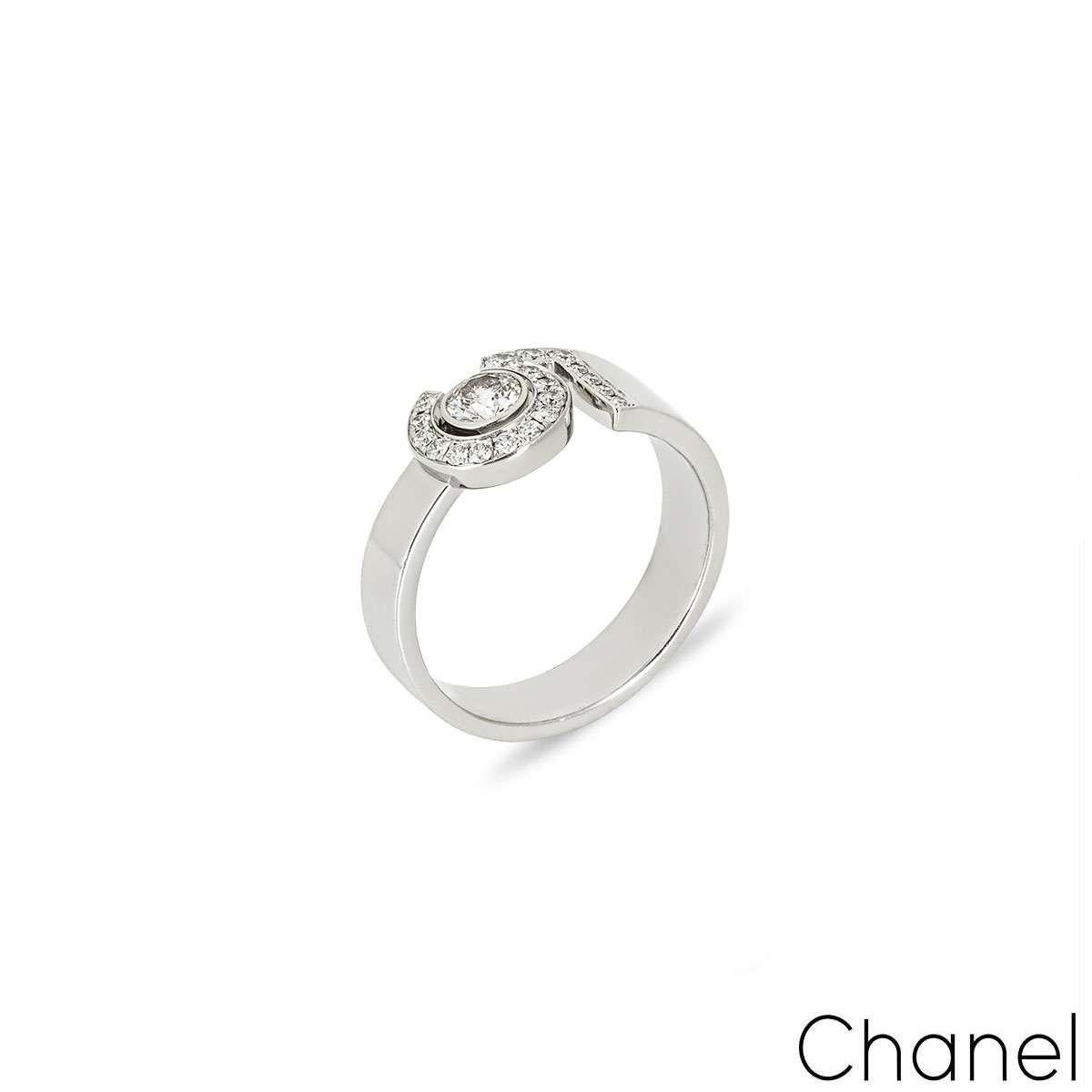 An 18k white gold diamond ring, by Chanel from their iconic No.5 collection. The ring comprises of a single round brilliant cut diamond (0.25ct) set in the centre which is surrounded by the number 5. The 5 is also diamond set, with a total of 19