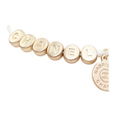 CHANEL white gold tone logo letter bead charm white thread lucky bracelet