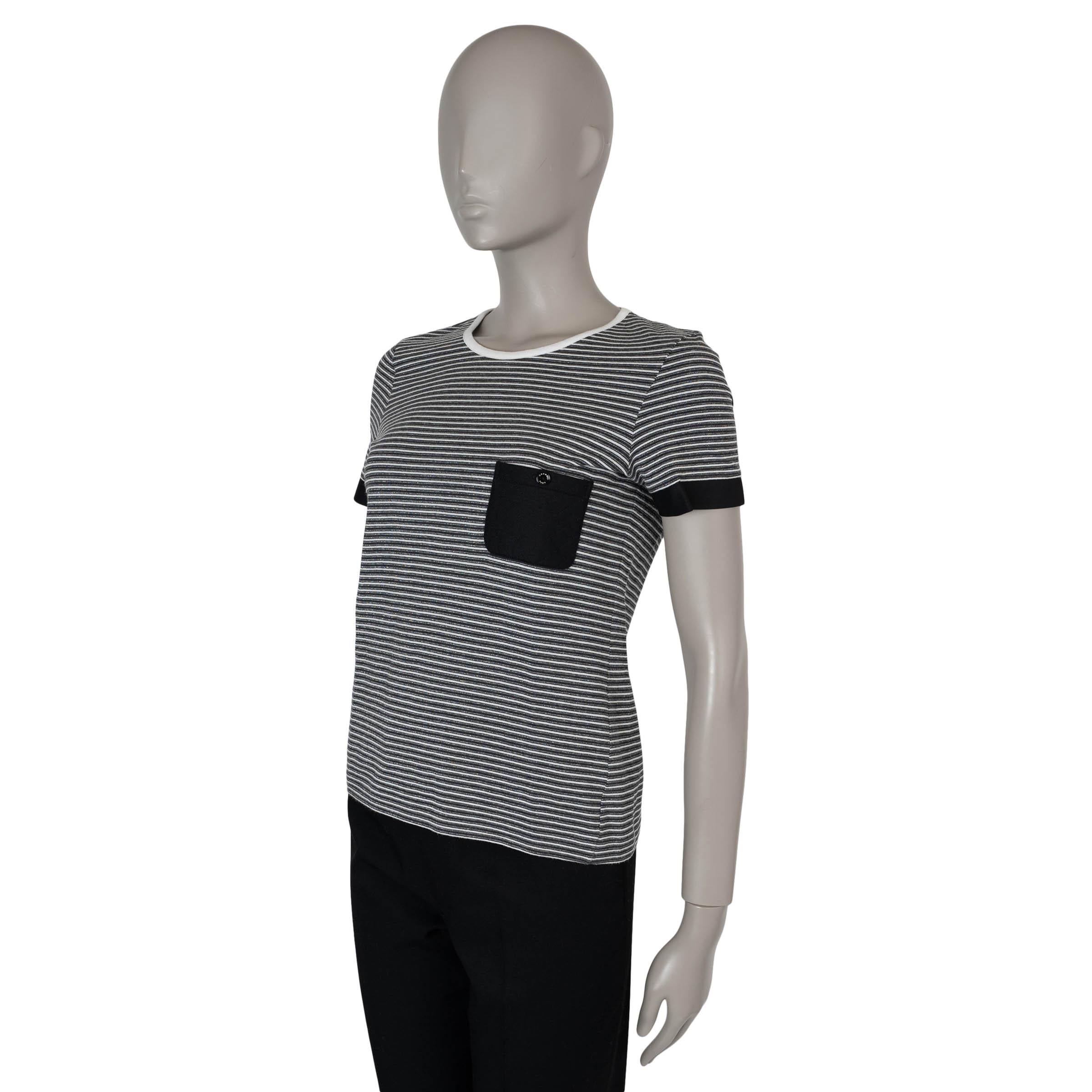 This 100% authentic Chanel knit T-shirt in white, grey, and black striped cotton blend with silver lurex embodies casual elegance with a touch of shimmer. Designed with contrasting trims, a classic crewneck, and a signature black quilted buttoned