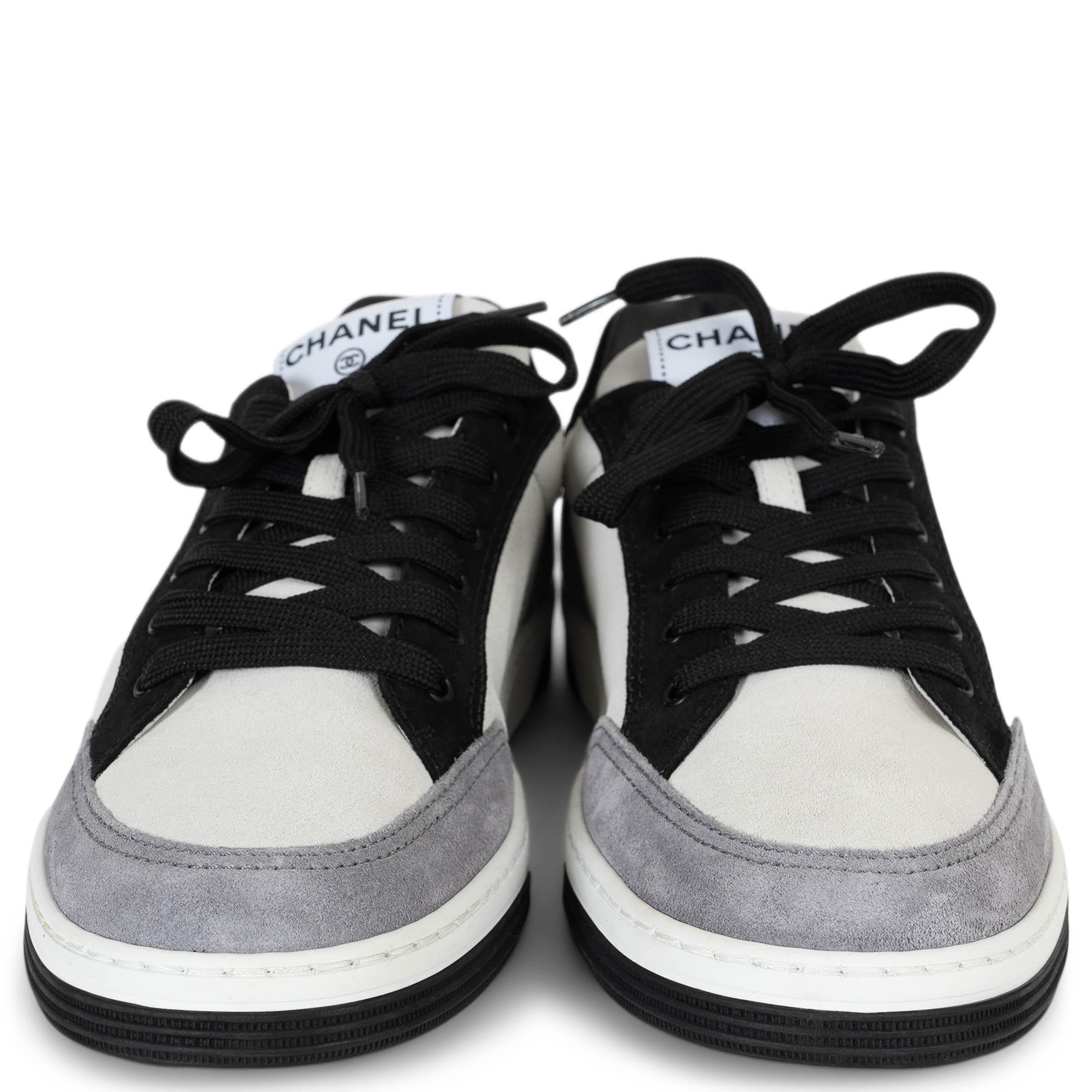 This 100% authentic Chanel low-top sneakers in cream suede offer a refined take on everyday luxury. Accented with light grey and black suede trims, they feature rounded toes for a timeless silhouette. A black signature stamp on the outer sides adds