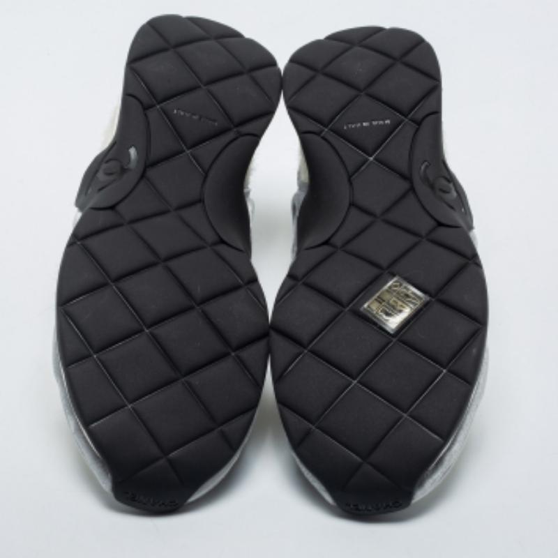 Chanel puts a fashionable spin on the classic low-top sneaker with this pair. These authentic designer sneakers are constructed using a mix of materials, secured with lace-ups, and finished with rubber soles.