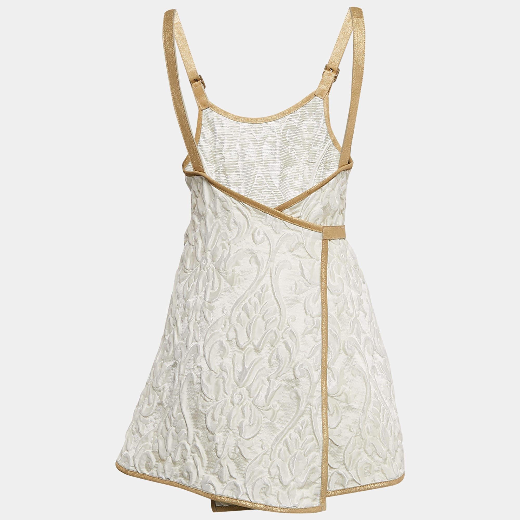 Chanel elevates the classic wrap dress with this stunning white jacquard mini  accented by rich golden suede trim. The textured jacquard fabric and sleek design create a perfect harmony of elegance and luxury  while the wrap style ensures a