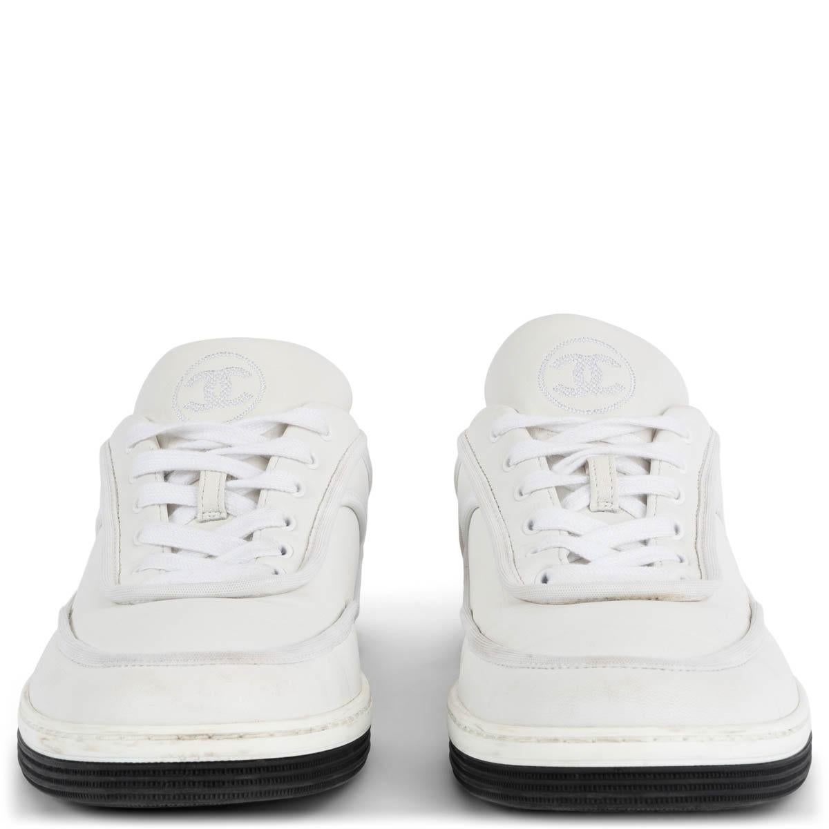 100% authentic Chanel 2021 low-top sneakers in white smooth leather with a black & white rubber sole. Have been worn and show a faint scratch on the left shoe. Overall in excellent condition. 

Measurements
Model	Chanel21S G37488
Imprinted Size	38.5