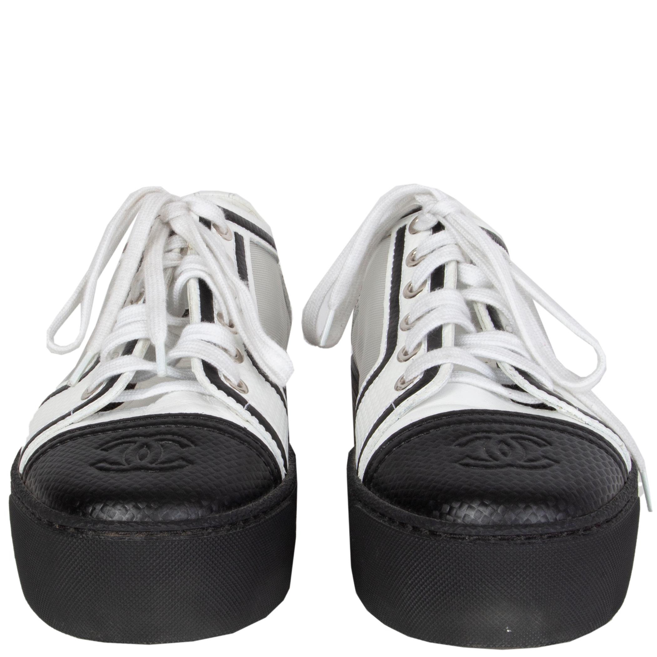 Chanel lace-up platform sneakers in black and white leather with white mesh parts on the side. CC logo embossed on the tip. Have been worn and are in excellent condition. 

Imprinted Size 37.5
Shoe Size 37.5
Inside Sole 23.5cm (9.2in)
Width 7.5cm