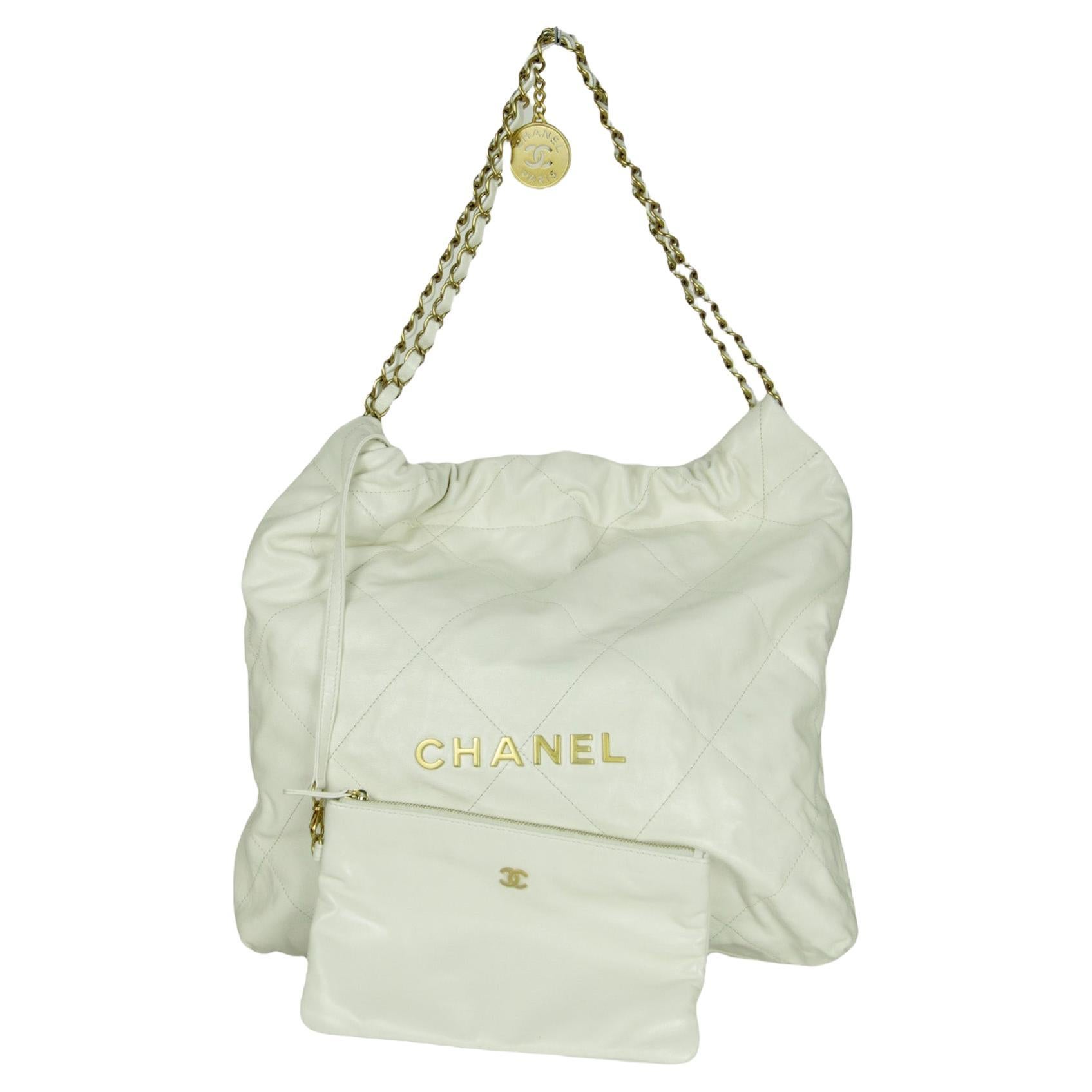 Chanel White Leather Chanel 22 Tote Bag. Features gold hardware spelling out CHANEL

Made In: Italy
Color: White
Hardware: Goldtone
Materials: Leather, metal
Lining: Beige textile
Closure/Opening: Open top 
Exterior Pockets: None
Interior Pockets: