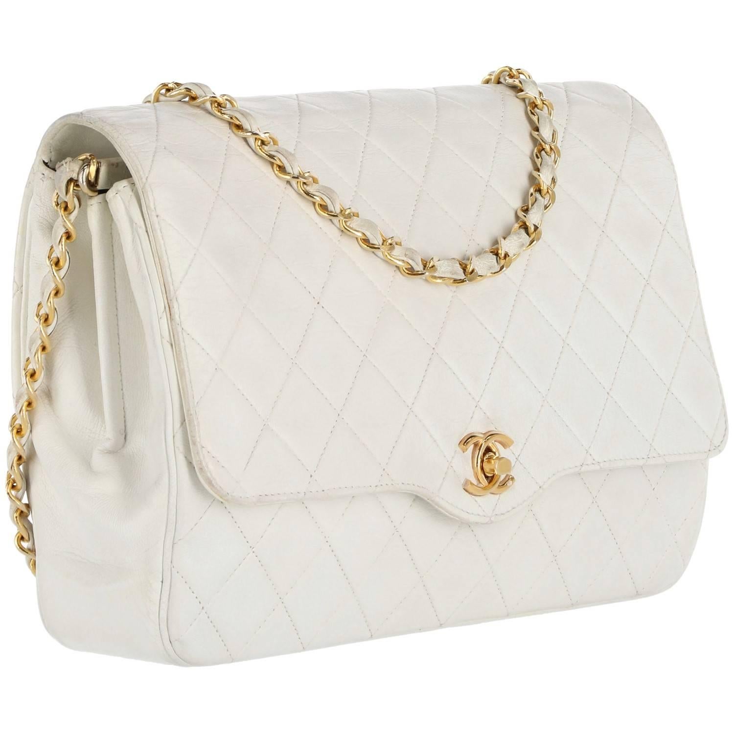 Beautiful Chanel matelassé leather bags in white color with gold chain shoulder strap, braided with leather. It features a classic flap and double 