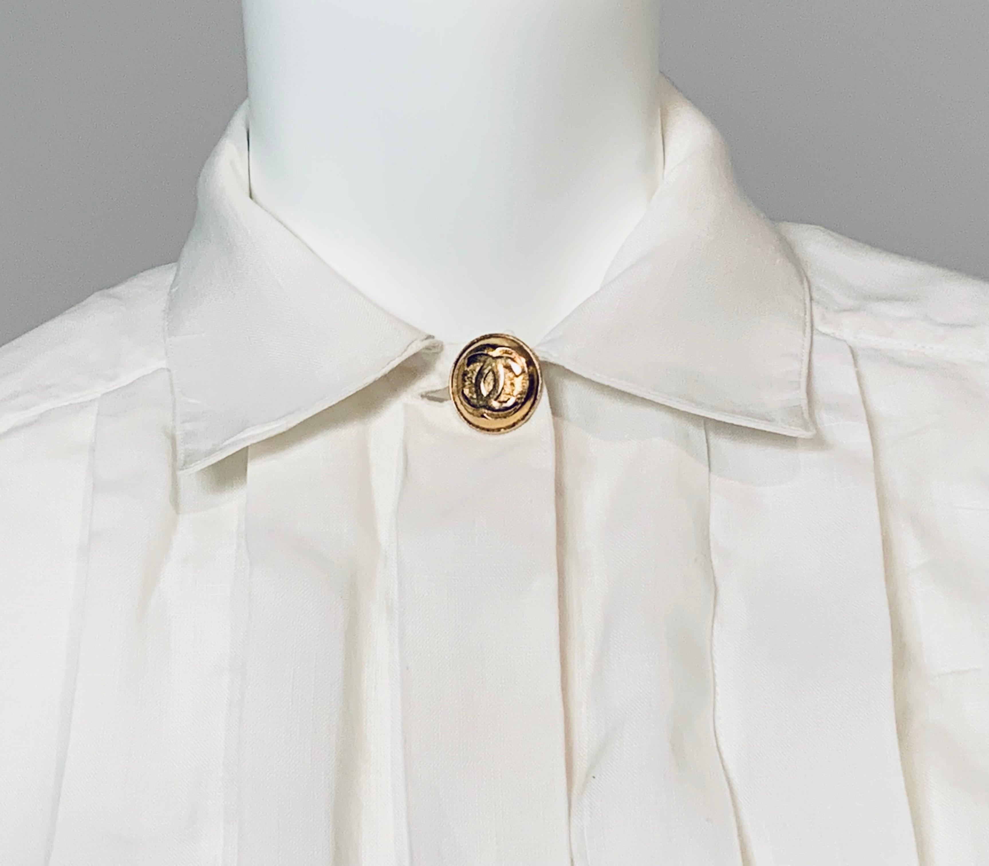 This Chanel blouse has tuxedo pleats, a large double C button at the collar and French cuffs with  Chanel double C logo cufflinks. It is in excellent condition. The size tag has been removed so please check the measurements.
Shoulders 17.5