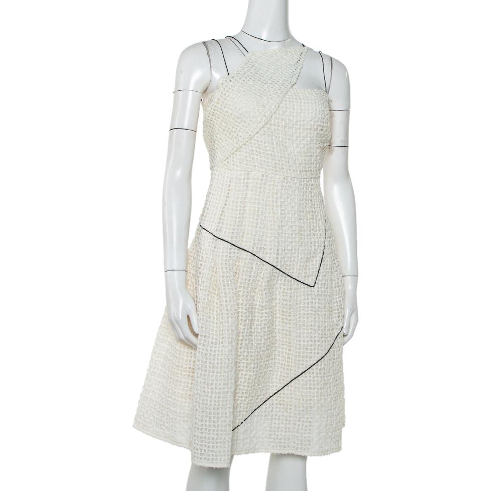 This smart dress comes from the house of Chanel. Known for its timeless and sophisticated ensembles, this mini dress is no different. Crafted from quality materials, this tweed creation comes in a lovely white hue. It is great for playful occasions,