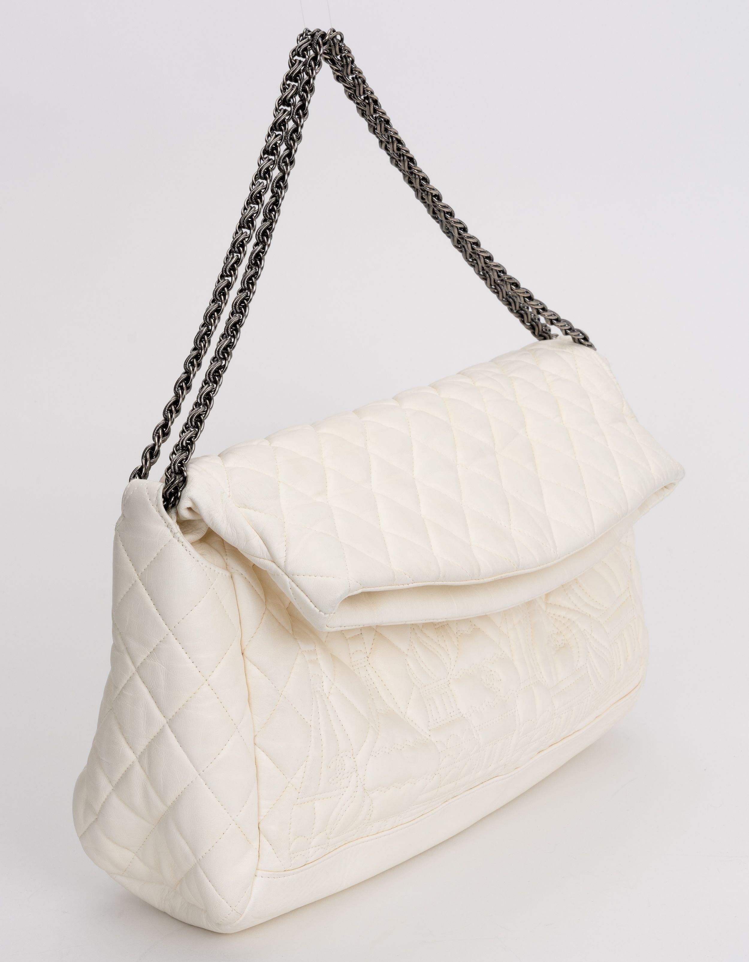 Chanel Quilted Paris Moscou square bag in Ivory Lambskin, with diamond stitch. A silver chain top with a Chanel CC medallion. Top folds over too close. Mint condition. 
Shoulder drop 6.5