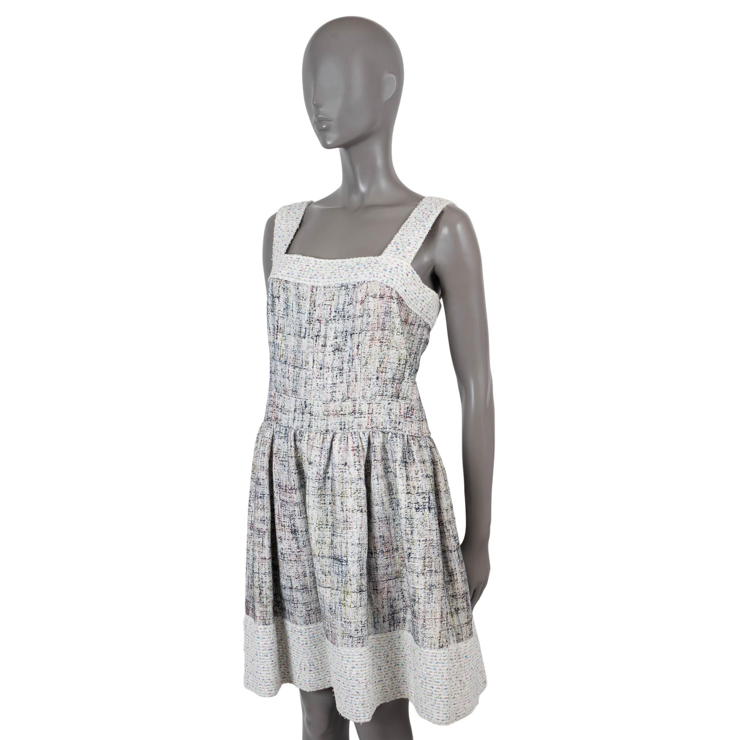 100% authentic Chanel sleeveless tweed dress in cream, green, blue and pink cotton (90%) and rayon (10%). Features a square neckline with contrasting trims and bottom hem, a tonal waist band and pleated skirt. Opens with two faux pearl buttons and a
