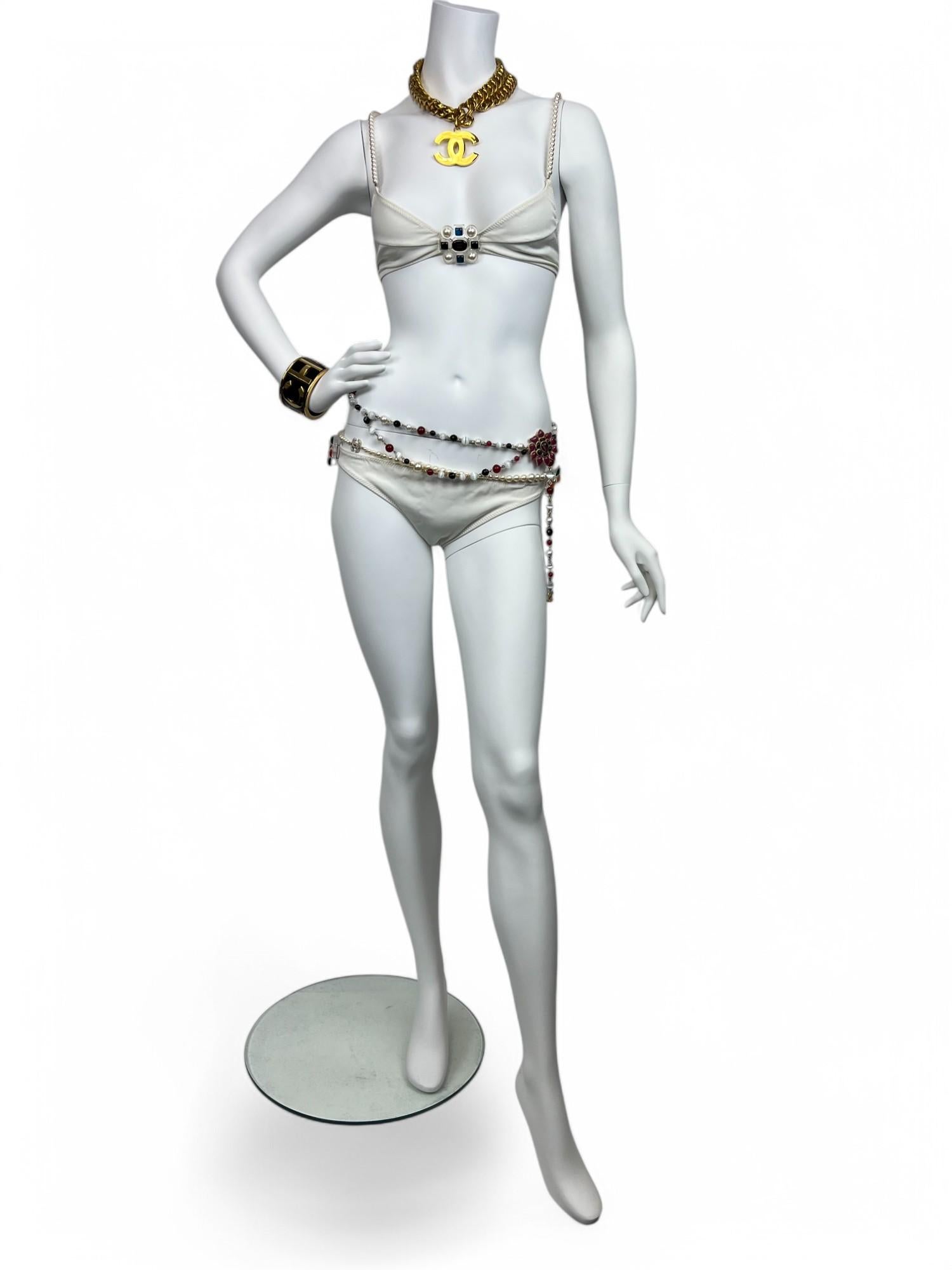 An extraordinary and highly coveted piece from Chanel’s early 1990s collections, this White Pearl & Lucite Jeweled Bathing Suit is a true collector’s treasure. Reflecting Karl Lagerfeld’s visionary approach during his reign at the house, the suit