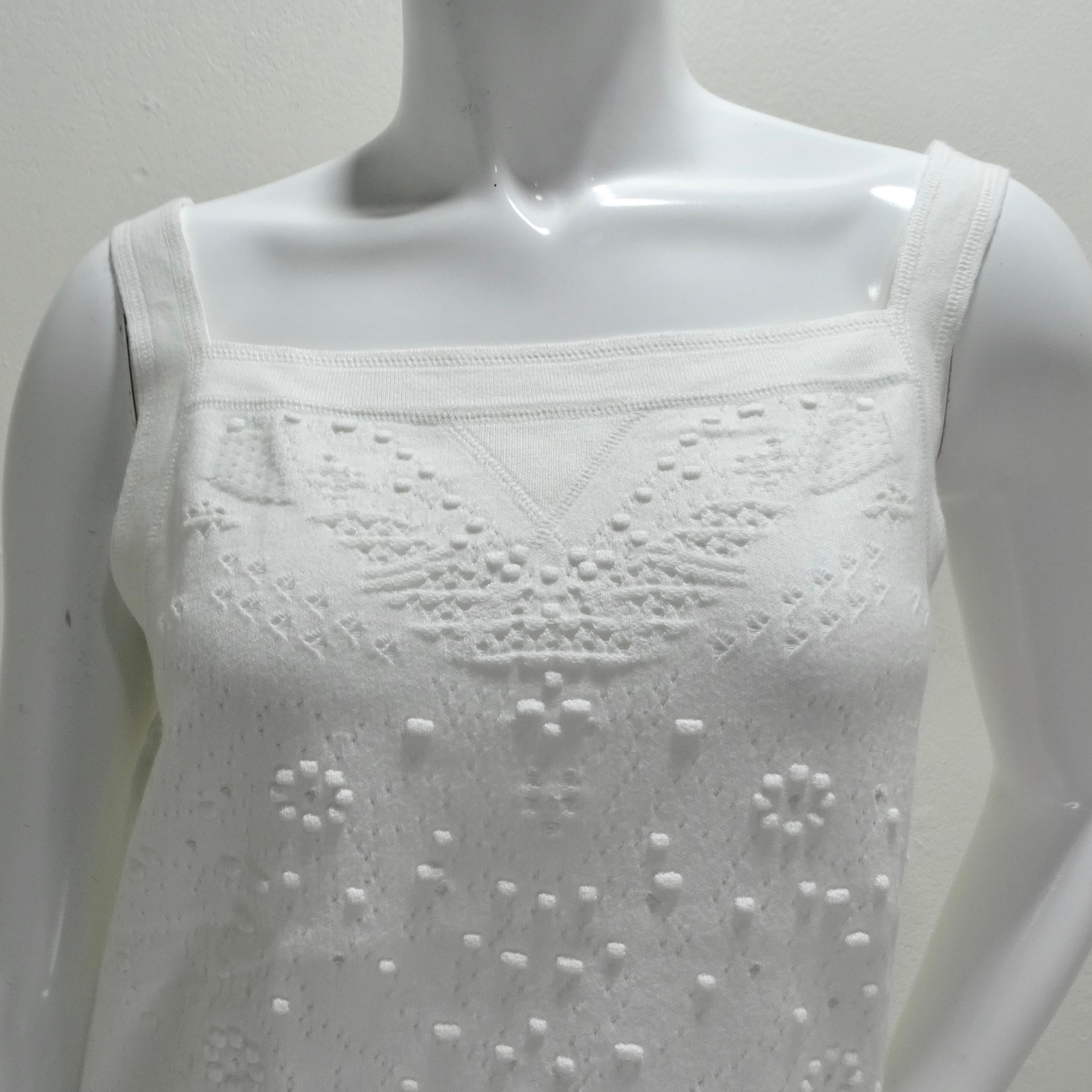 The Chanel White Perforated Knit Tank Top is a classic yet distinctive piece that showcases Chanel's commitment to timeless elegance and artisanal craftsmanship. This tank top, with its straight neckline, is composed of a white cotton knit featuring