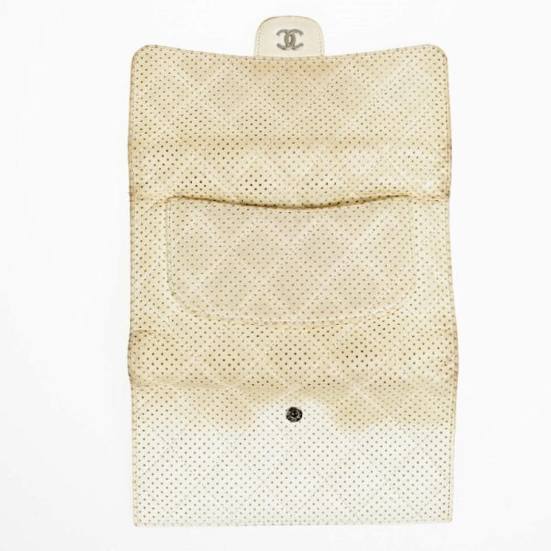 Complement your bag with this fab Chanel White Perforated Continental Wallet. It is crafted from perforated quilted white leather and features a front flap. The interior is lined with leather and houses 6 credit card slots, four bill compartments