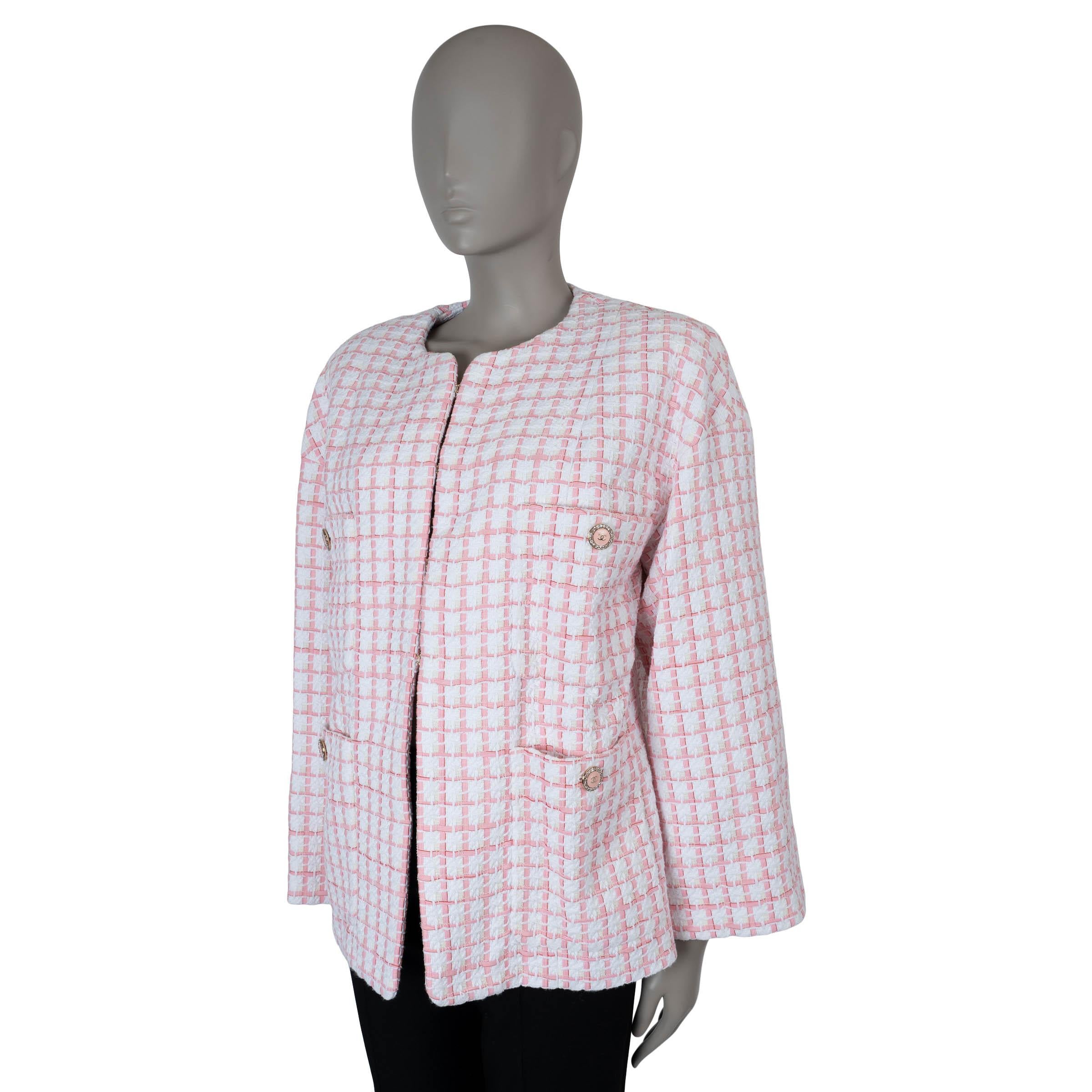 This 100% authentic Chanel collarless tweed jacket is crafted from a blend of white cotton (36%), acrylic (31%), polyamide (14%), polyester (11%), and wool (8%) with pink ribbon detailing. It features an oversized, boxy silhouette and the classic