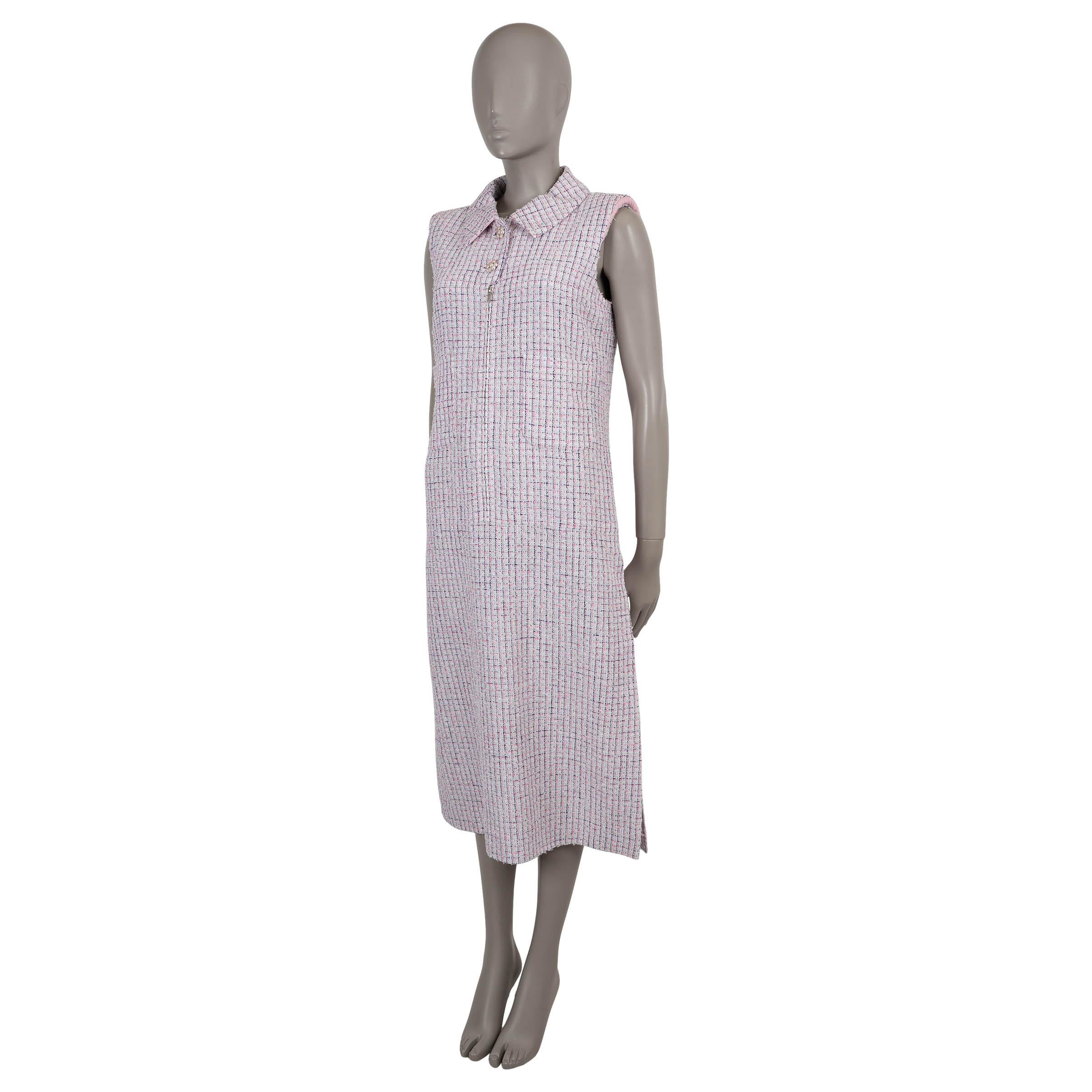 This 100% authentic Chanel shirt dress is crafted in a white, bright pink, and navy blue grid tweed blend (61% polyester, 21% acrylic, 9% nylon, 8% viscose, 1% metal) accented with subtle silver lurex threads. Designed with a sleeveless, fitted