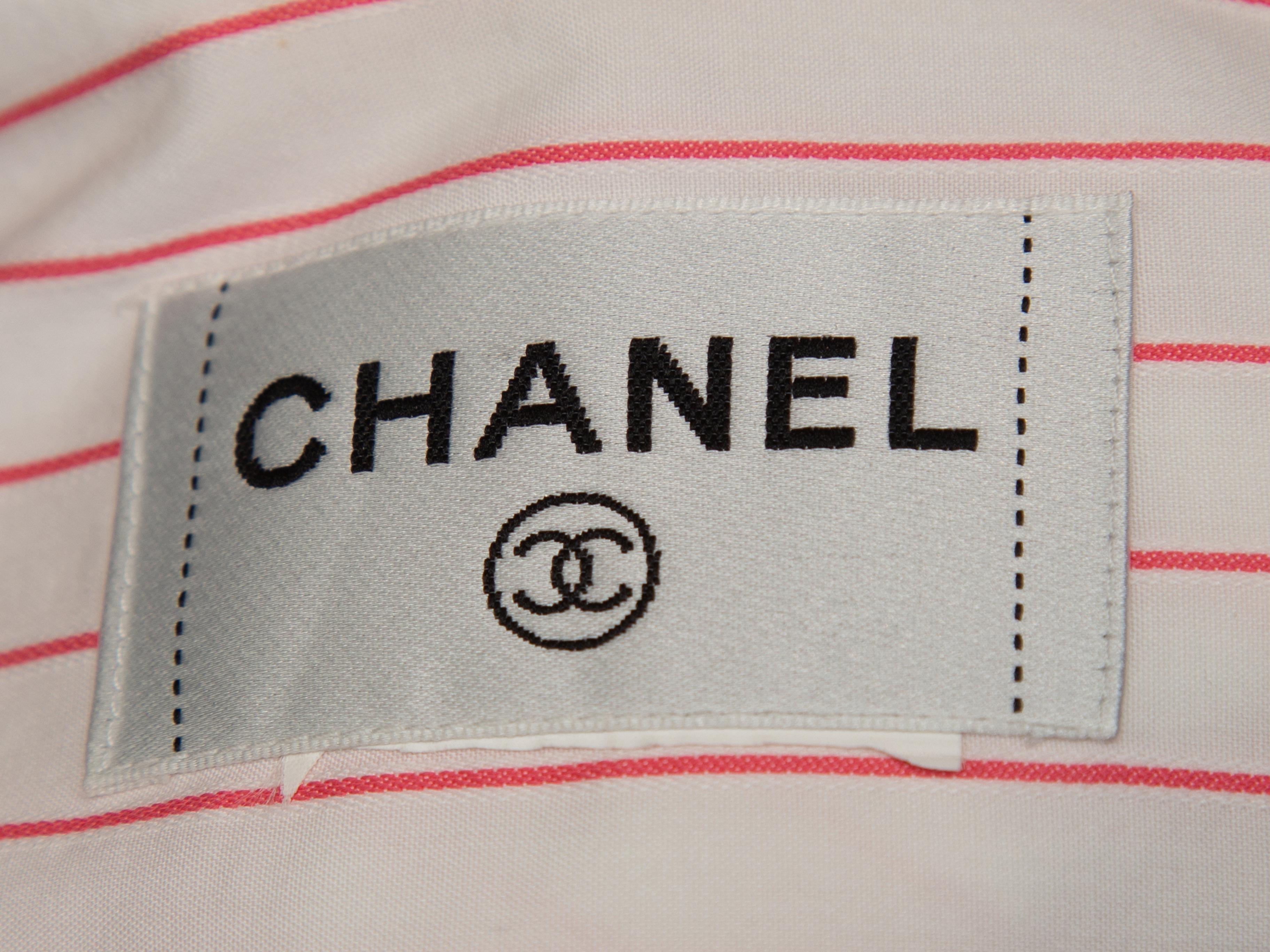 Product details: White and pink sleeveless striped button-up top by Chanel. Pointed collar. CC button closures at center front. Designer size 42. 40