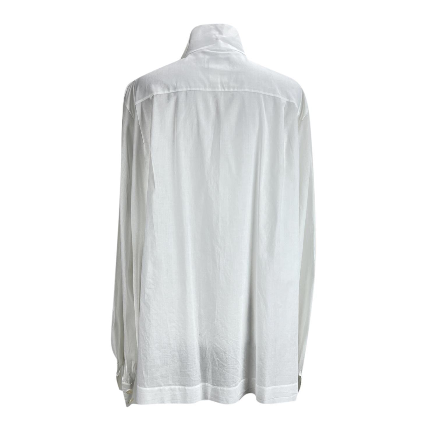 Chanel white blouse shirt with front pintucked bib. Button closure on the front. Long sleeve with buttoned cuffs. 2 front pockets. Composition: 100% cotton. Size: 38 FR (The size shown for this item is the size indicated by the designer on the