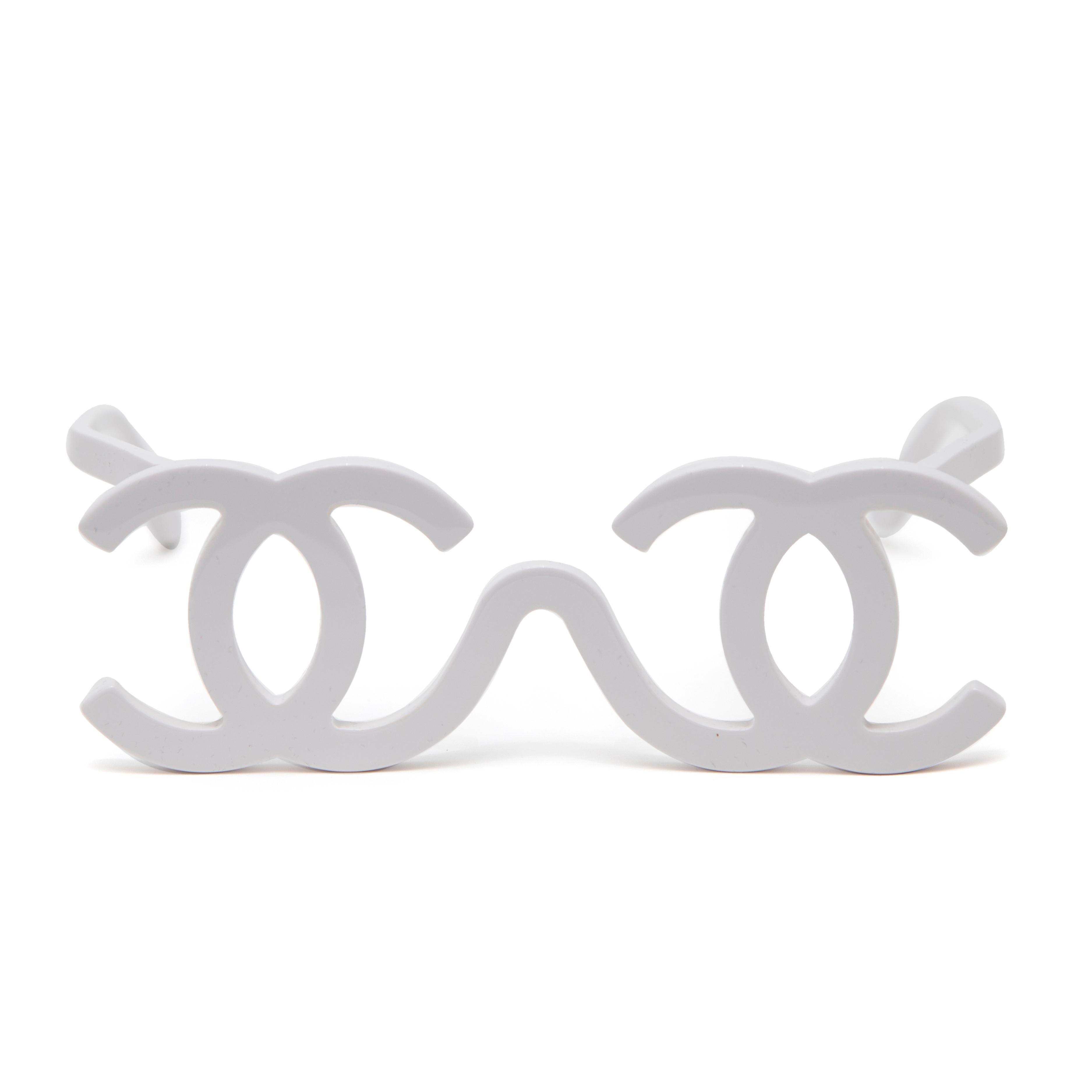 Presenting the Chanel White Plastic Logo Eyeglasses, a chic accessory designed by Karl Lagerfeld for the Autumn Winter 1994 collection. These eyeglasses feature a striking white plastic frame, accentuated by the iconic interlocking CC logo for the