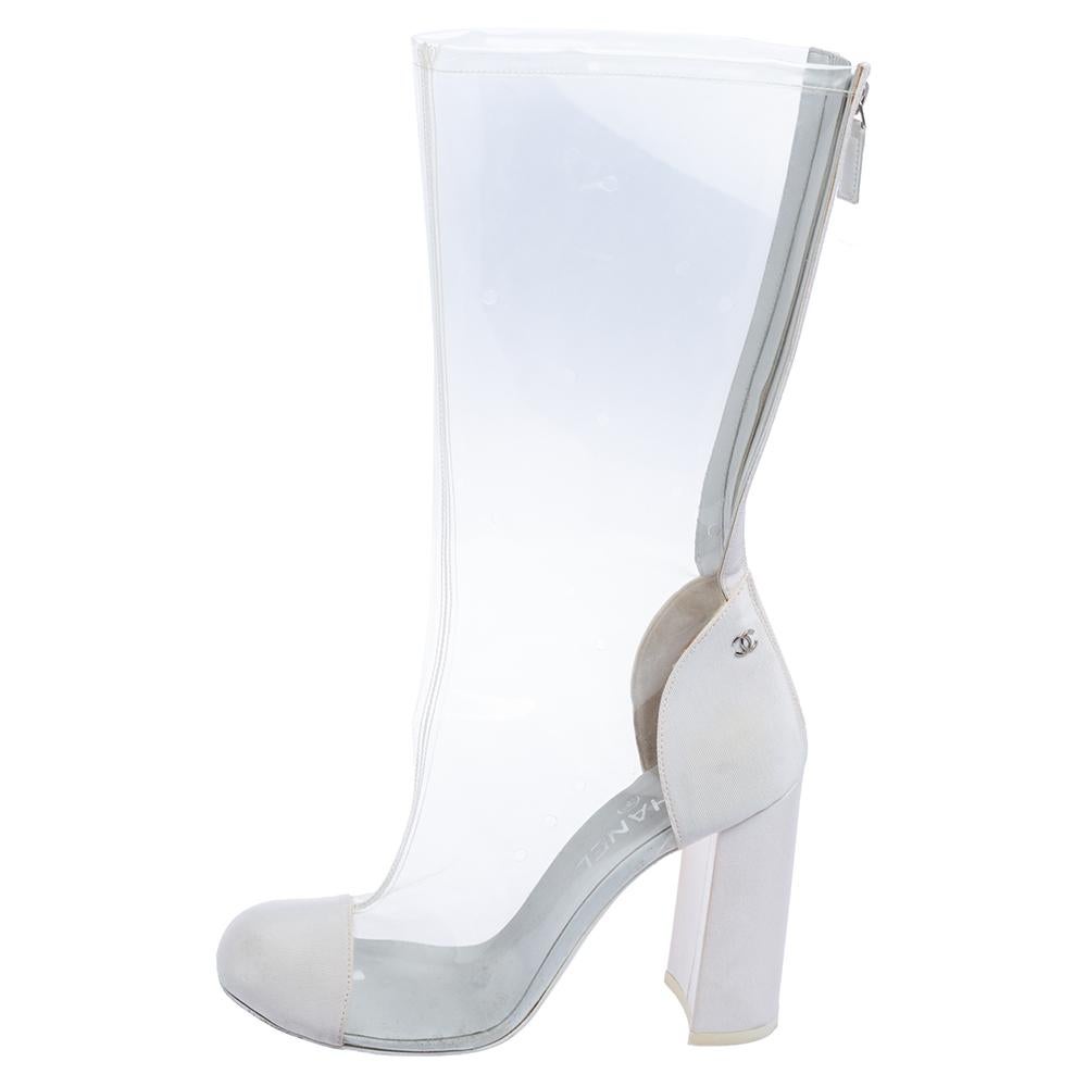 Make heads turn with these Chanel mid-calf boots that are crafted from PVC and canvas. They flaunt a white hue, rounded toes, zippers, and 10 cm block heels. Team them with mini dresses and skirts alike!

Includes: Original Dustbag