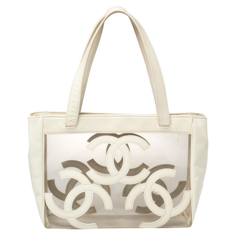 A lovely and unique creation from the house of Chanel, this Triple CC tote makes for an ideal bag for shopping outings, Sunday brunches, and beach days. Rendered in clear PVC with white patent leather trims, the tote is styled with three CC logos