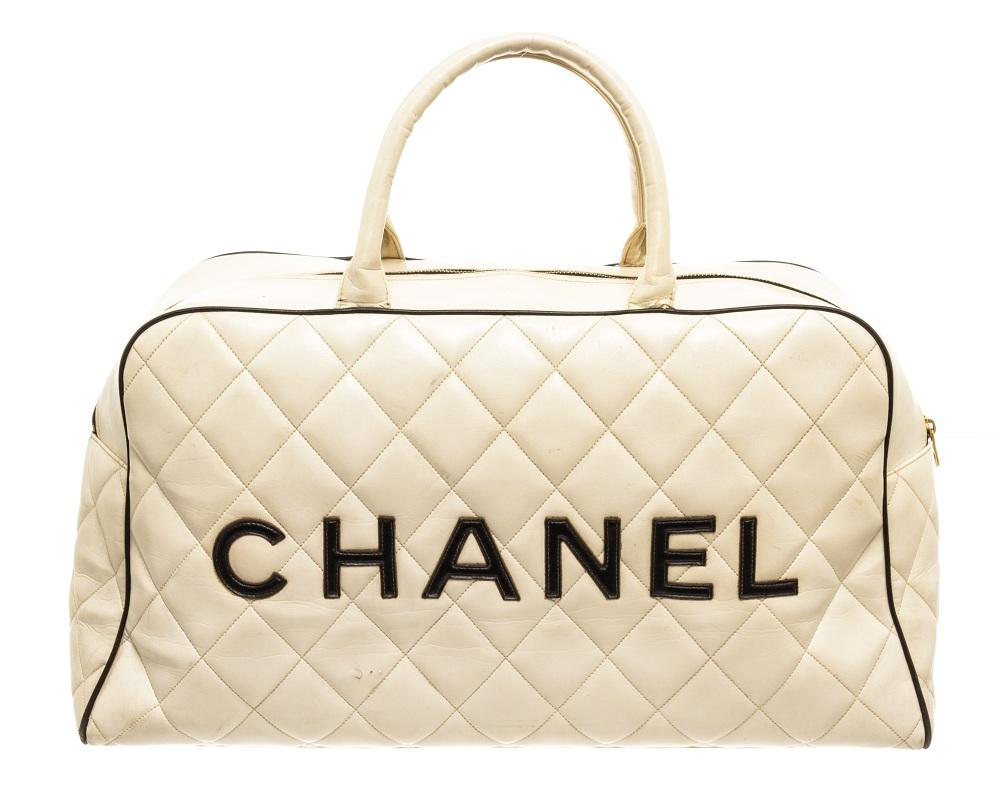 Chanel White Quilted Bowling Bag features gold-tone hardware, black leather lining and trim, zip pocket on the interior and exterior, with two white leather top handles and top zip closure. 

770142MSC
