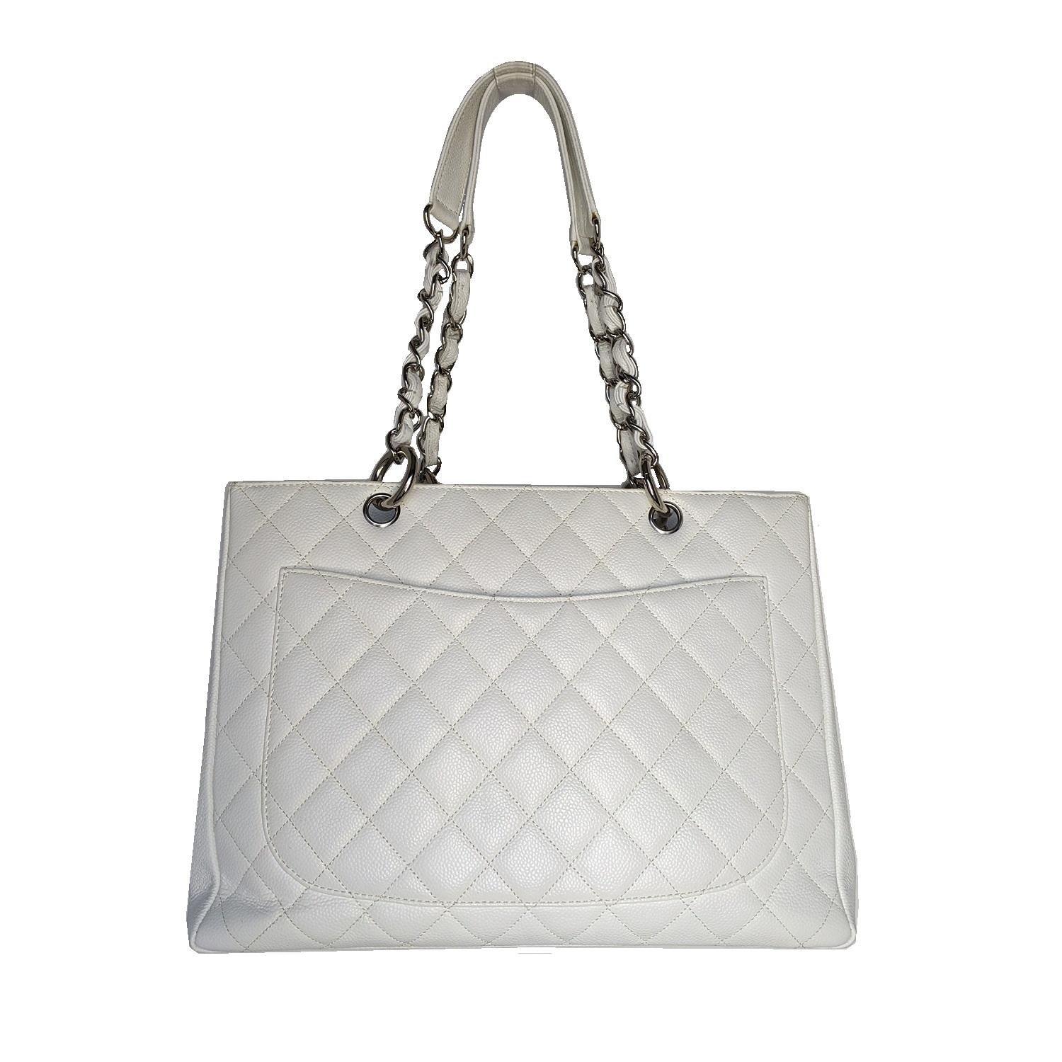 This stylish tote is crafted of diamond-quilted caviar leather in white. This shoulder bag features leather-threaded polished silver chain-link shoulder straps with shoulder pads, a quilted Chanel CC logo on the front, and a flat pocket on the rear.