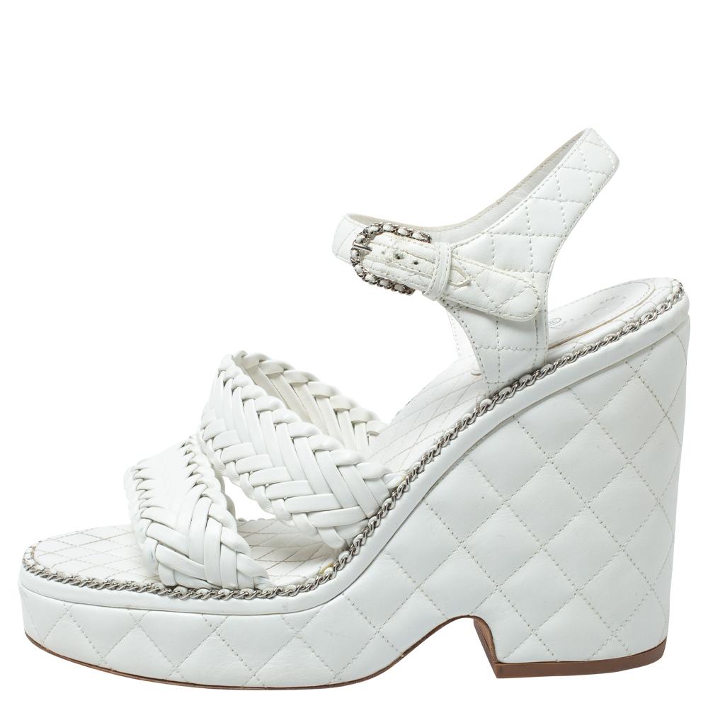 There will always be room in a woman's shoe closet for a pair of Chanel's shoes. We have here a gorgeous pair in white leather. The sandals are quilted and they feature woven straps, buckle closure, and 12 cm heels supported by platforms.

