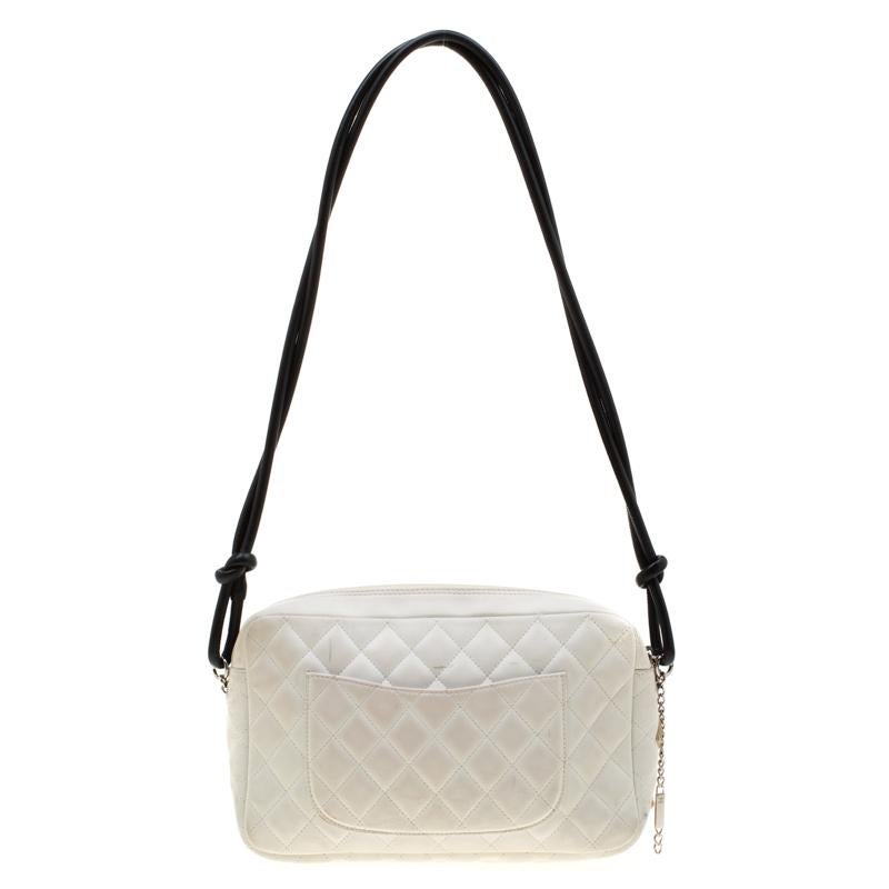 If you're looking for the perfect every day yet sophisticated bag to hold your things in style, then look no further than this Chanel white Camera bag! It will easily carry all your necessities. It features a white smooth leather exterior with