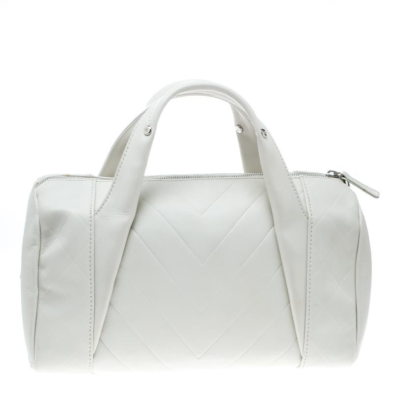 Structured into a boxy silhouette, this satchel bag from the worlds’ famous fashion brand, Chanel is a creative piece. Its grace lies in the standout white hue and the signature quilted pattern with a refreshing tweak and sophistication comes