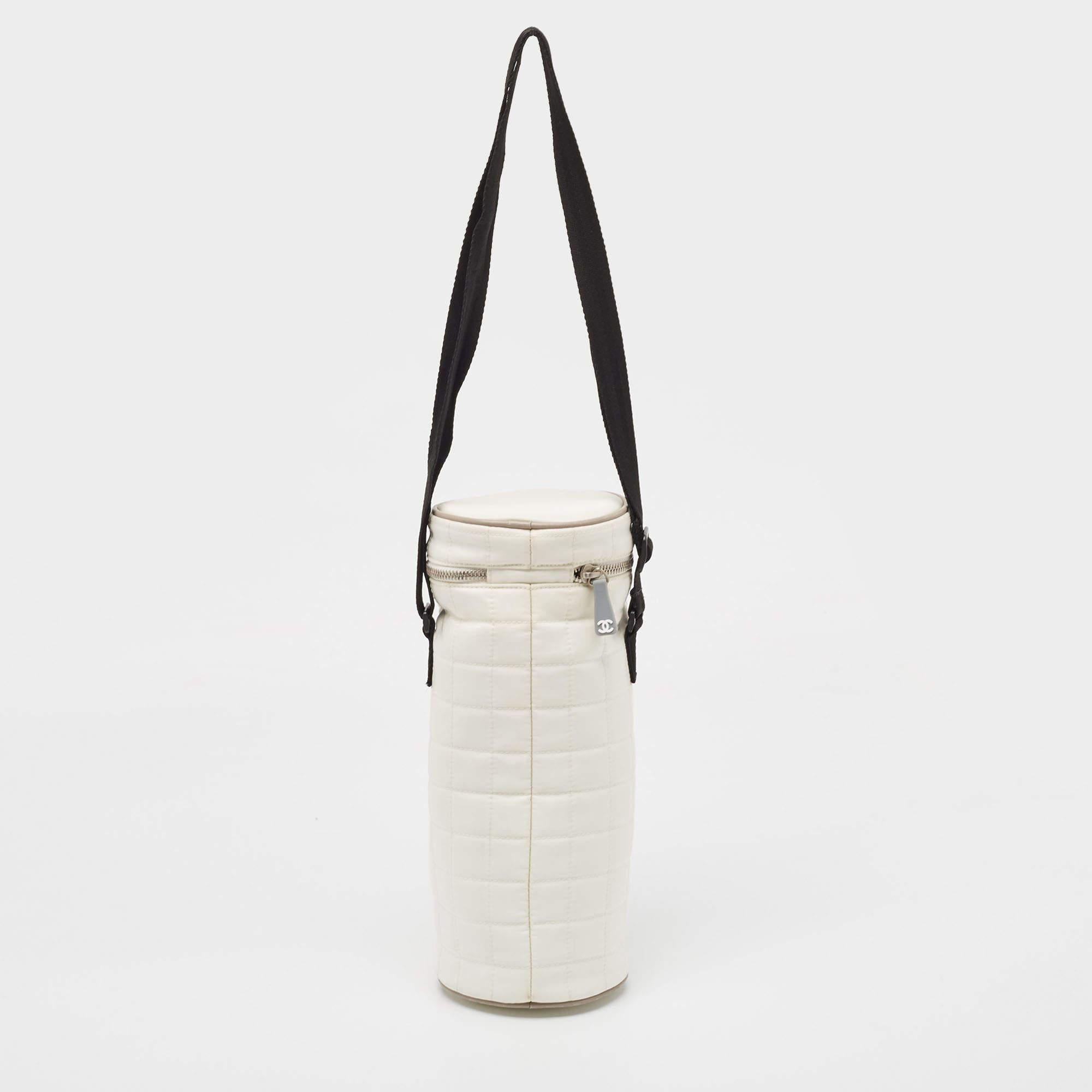 Chanel's bottle holder is perfect for when you're off to the gym or to the office. It is made of quilted nylon and it has a zip closure, front CC logo, and an adjustable strap.

