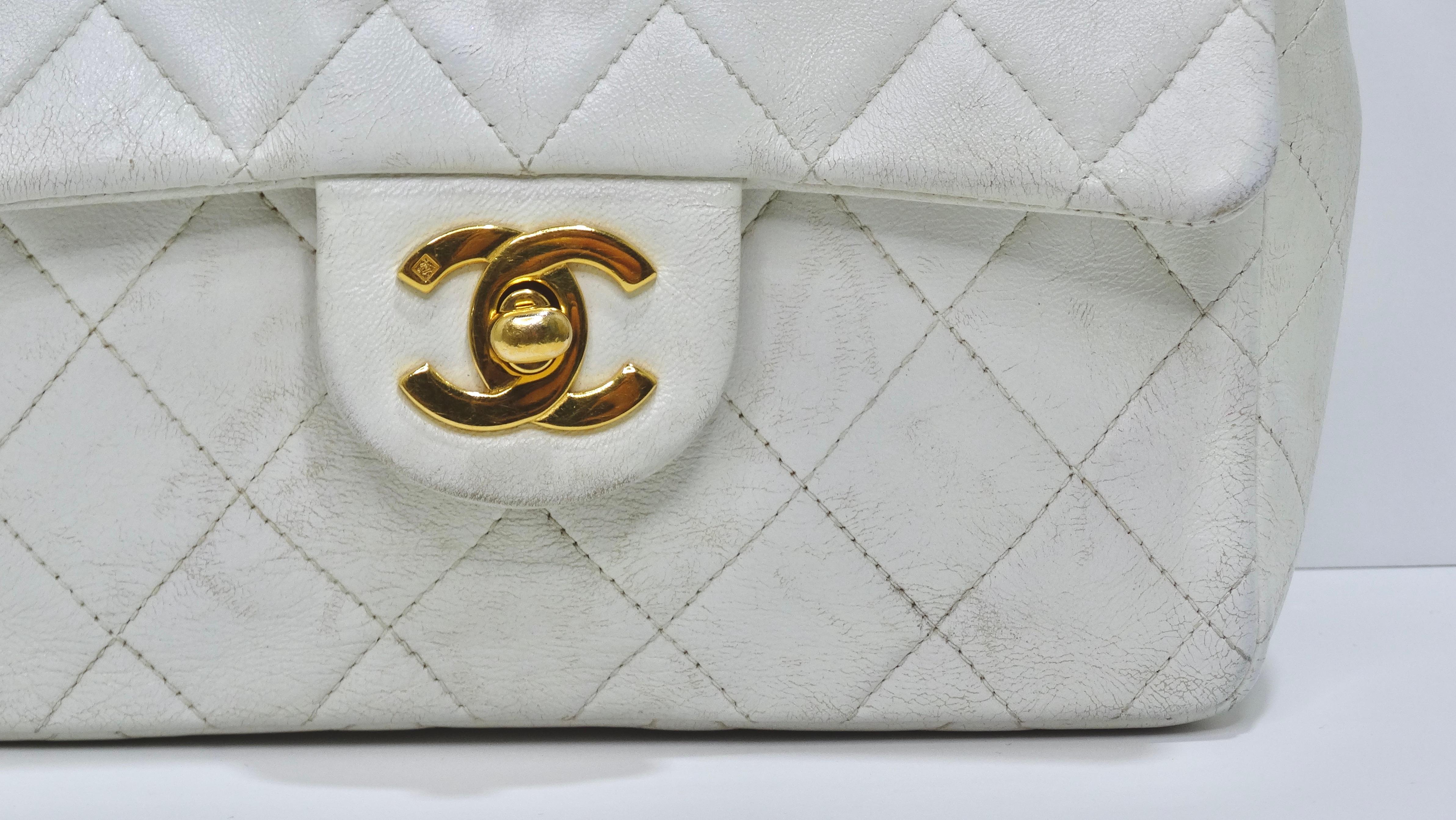 You can't go wrong with this adorable and versatile Chanel crossbody bag! This is a vintage Chanel find that dates back to the mid-1990's. This bag is featured in a soft white leather in a mini size with a square shape. It has gold-tones hardware,