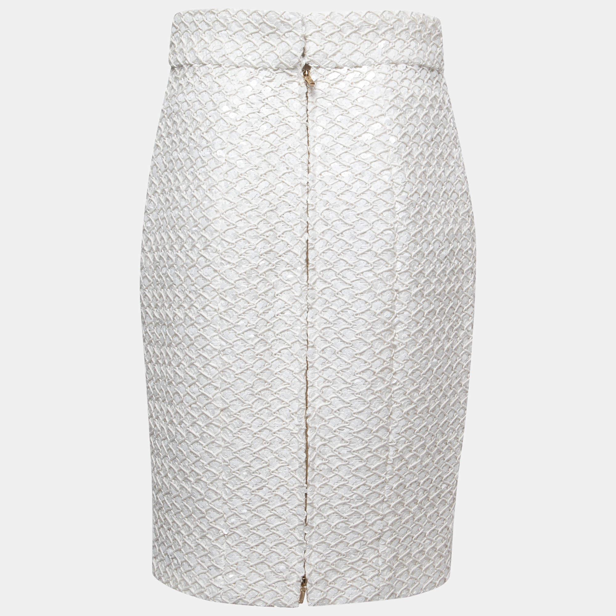 The Chanel skirt is a glamorous fashion piece. It features a form-fitting silhouette, adorned with delicate white sequins, which catch and reflect light beautifully. This skirt exudes sophistication and is perfect for formal events or a chic night