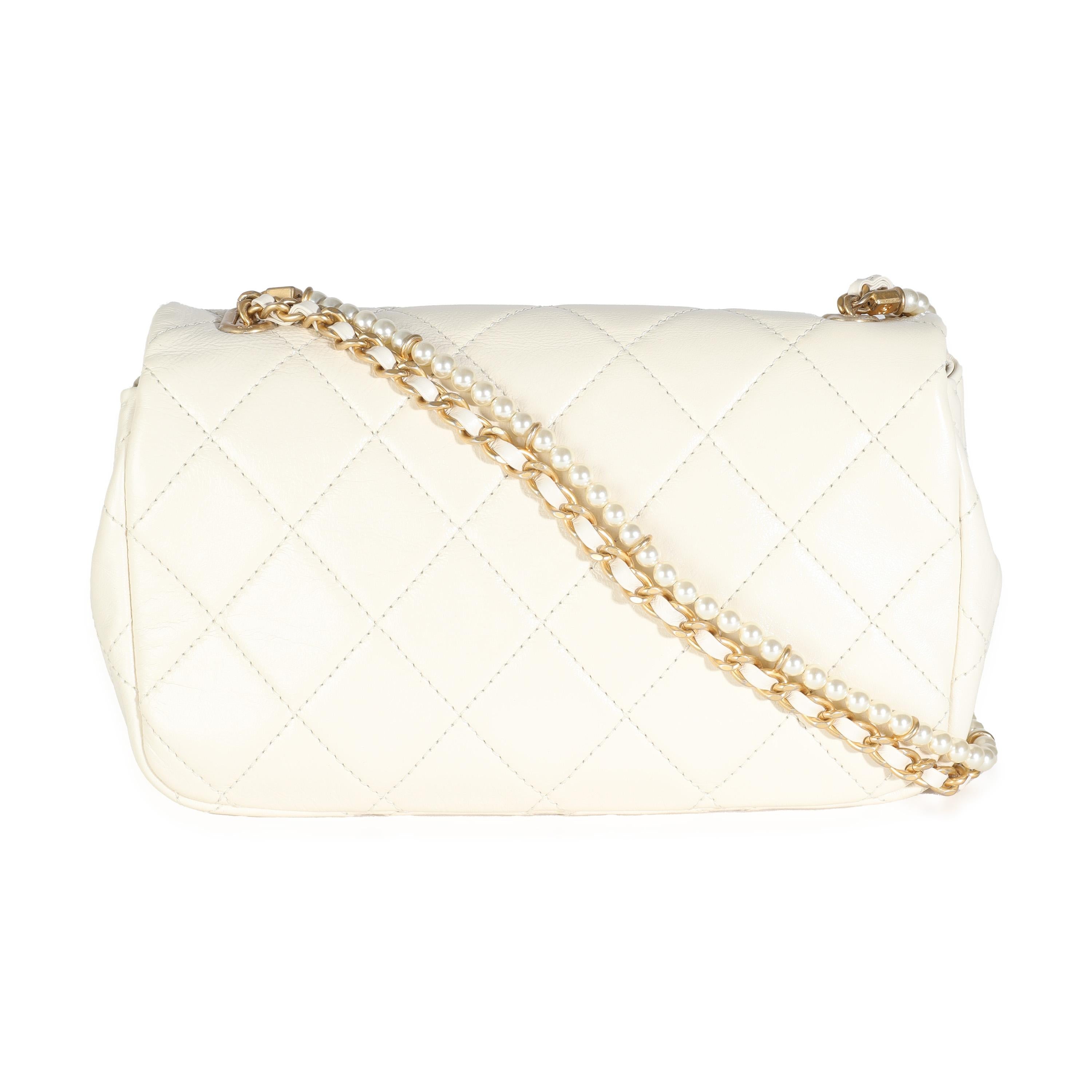 Listing Title: Chanel White Shiny Quilted Lambskin Pearl Chain Mini Flap Bag
SKU: 144168
Condition: Pre-owned 
Condition Description: A timeless classic that never goes out of style, the flap bag from Chanel dates back to 1955 and has seen a number