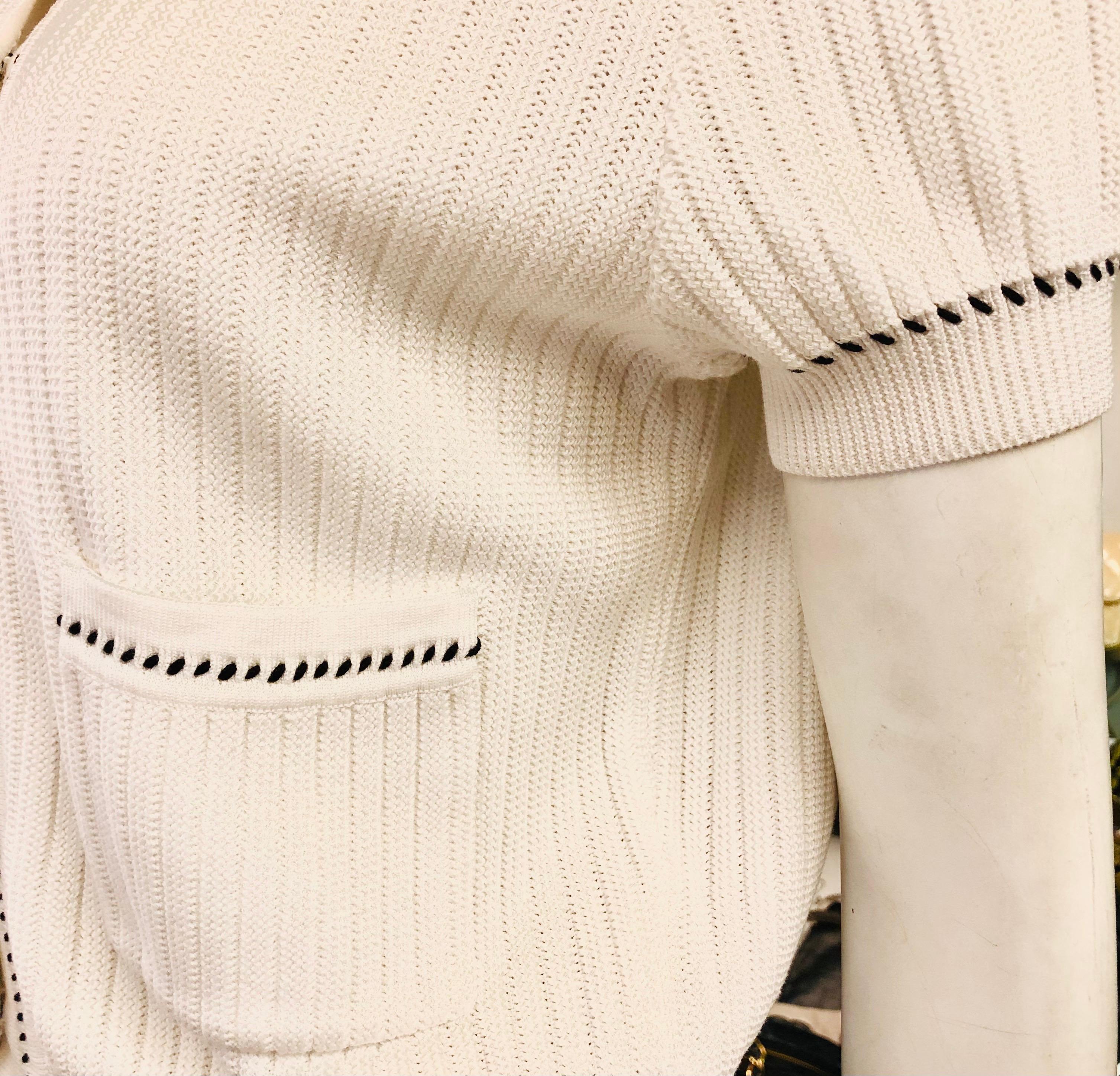 - Chanel white short sleeves knitted cotton cardigan from spring 1996 collection. 

- Black and white “CC” button closure. 

- Two front pockets. 

- Size 44.

- 100% cotton. 