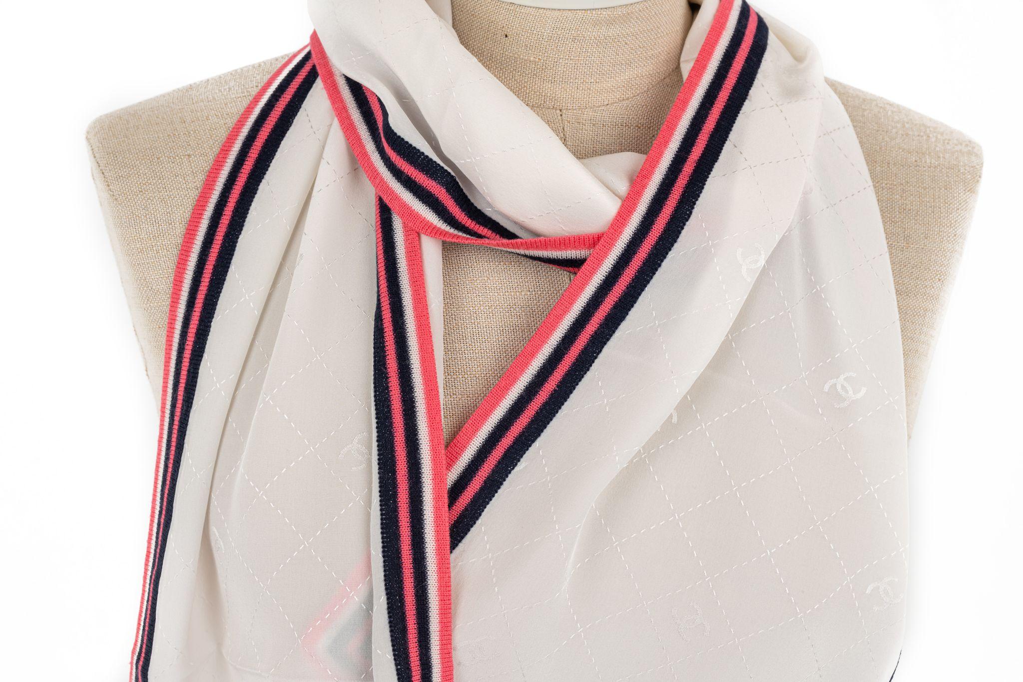 Chanel silk and wool mix stole in white with a multicolor frame. The piece is in excellent condition.